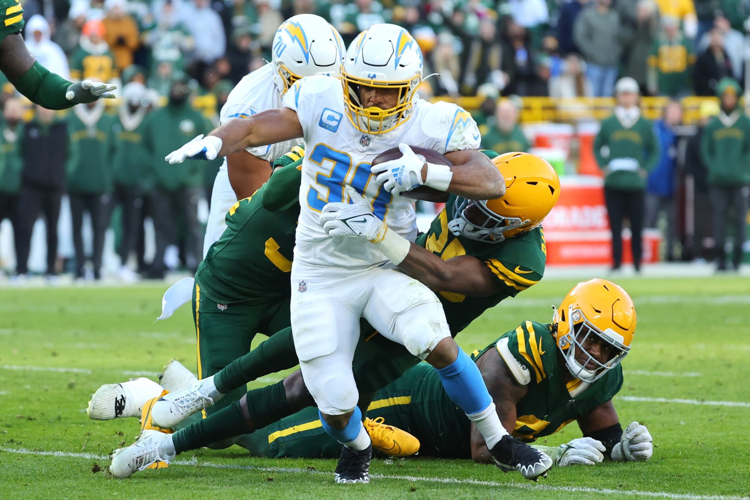 GREEN BAY, WISCONSIN - NOVEMBER 19: Austin Ekeler #30 of the Los Angeles Chargers runs with the ball while being tackled by Corey Ballentine #35 of the Green Bay Packers in the fourth quarter at Lambeau Field on November 19, 2023 in Green Bay, Wisconsin. (Photo by Stacy Revere/Getty Images) GREEN BAY, WISCONSIN - NOVEMBER 19: Austin Ekeler #30 of the Los Angeles Chargers runs with the ball while being tackled by Corey Ballentine #35 of the Green Bay Packers in the fourth quarter at Lambeau Field on November 19, 2023 in Green Bay, Wisconsin. (Photo by Stacy Revere/Getty Images)