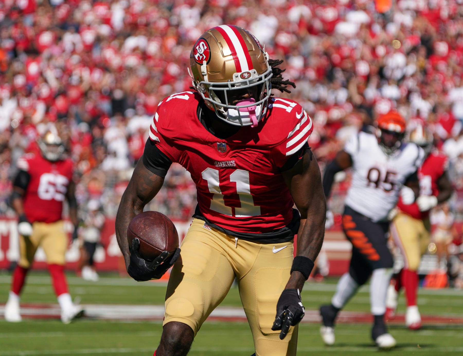 SANTA CLARA, CALIFORNIA - OCTOBER 29: Brandon Aiyuk #11 of the San Francisco 49ers runs with the ball during the first half of an NFL football game against the Cincinnati Bengals at Levi's Stadium on October 29, 2023 in Santa Clara, California. (Photo by Loren Elliott/Getty Images)