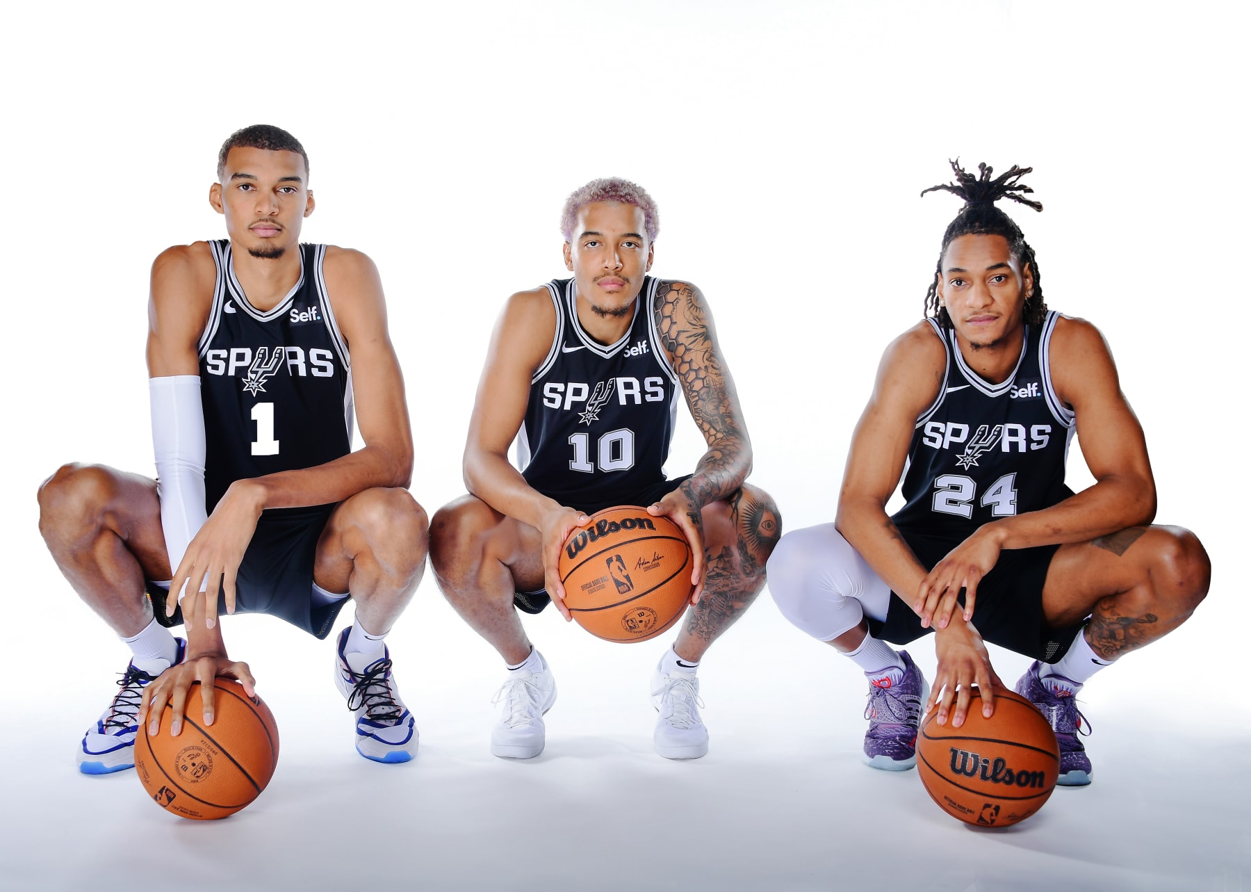 SAN ANTONIO, TX - OCTOBER 2: Devin Vassell #24, Jeremy Sochan #10 and Victor Wembanyama #1  of the San Antonio Spurs poses for a portrait during 2023-24 NBA Media Day on October 2, 2023 at the Frost Bank Center in San Antonio, Texas. NOTE TO USER: User expressly acknowledges and agrees that, by downloading and or using this photograph, user is consenting to the terms and conditions of the Getty Images License Agreement. Mandatory Copyright Notice: Copyright 2023 NBAE (Photos by Michael Gonzales/NBAE via Getty Images)