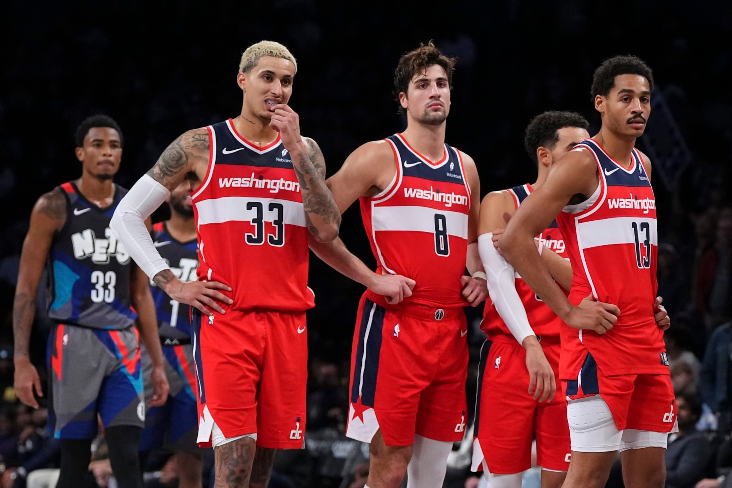 NEW YORK, NEW YORK - NOVEMBER 12: Kyle Kuzma #33, Deni Avdija #8, Tyus Jones #5, and Jordan Poole #13 of the Washington Wizards look on against the Brooklyn Nets at Barclays Center on November 12, 2023 in the Brooklyn borough of New York City. The Nets defeated the Wizards 102-94. NOTE TO USER: User expressly acknowledges and agrees that, by downloading and or using this photograph, User is consenting to the terms and conditions of the Getty Images License Agreement. (Photo by Mitchell Leff/Getty Images) NEW YORK, NEW YORK - NOVEMBER 12: Kyle Kuzma #33, Deni Avdija #8, Tyus Jones #5, and Jordan Poole #13 of the Washington Wizards look on against the Brooklyn Nets at Barclays Center on November 12, 2023 in the Brooklyn borough of New York City. The Nets defeated the Wizards 102-94. NOTE TO USER: User expressly acknowledges and agrees that, by downloading and or using this photograph, User is consenting to the terms and conditions of the Getty Images License Agreement. (Photo by Mitchell Leff/Getty Images)