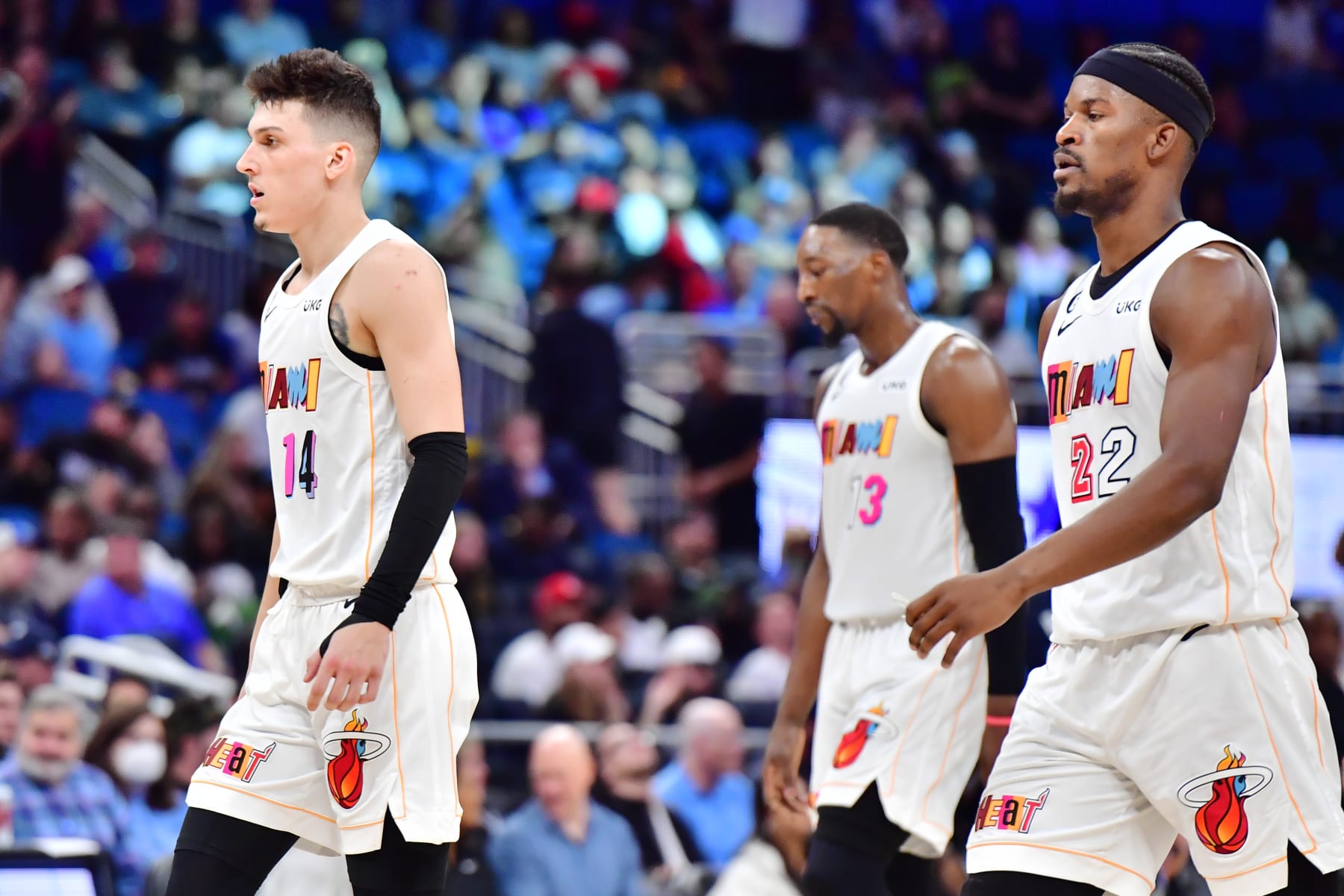 ORLANDO, FLORIDA - FEBRUARY 11: (L-R) Tyler Herro #14, Bam Adebayo #13 and Jimmy Butler #22 of the Miami Heat walk off the court during a timeout in overtime against the Orlando Magic at Amway Center on February 11, 2023 in Orlando, Florida. (Photo by Julio Aguilar/Getty Images)