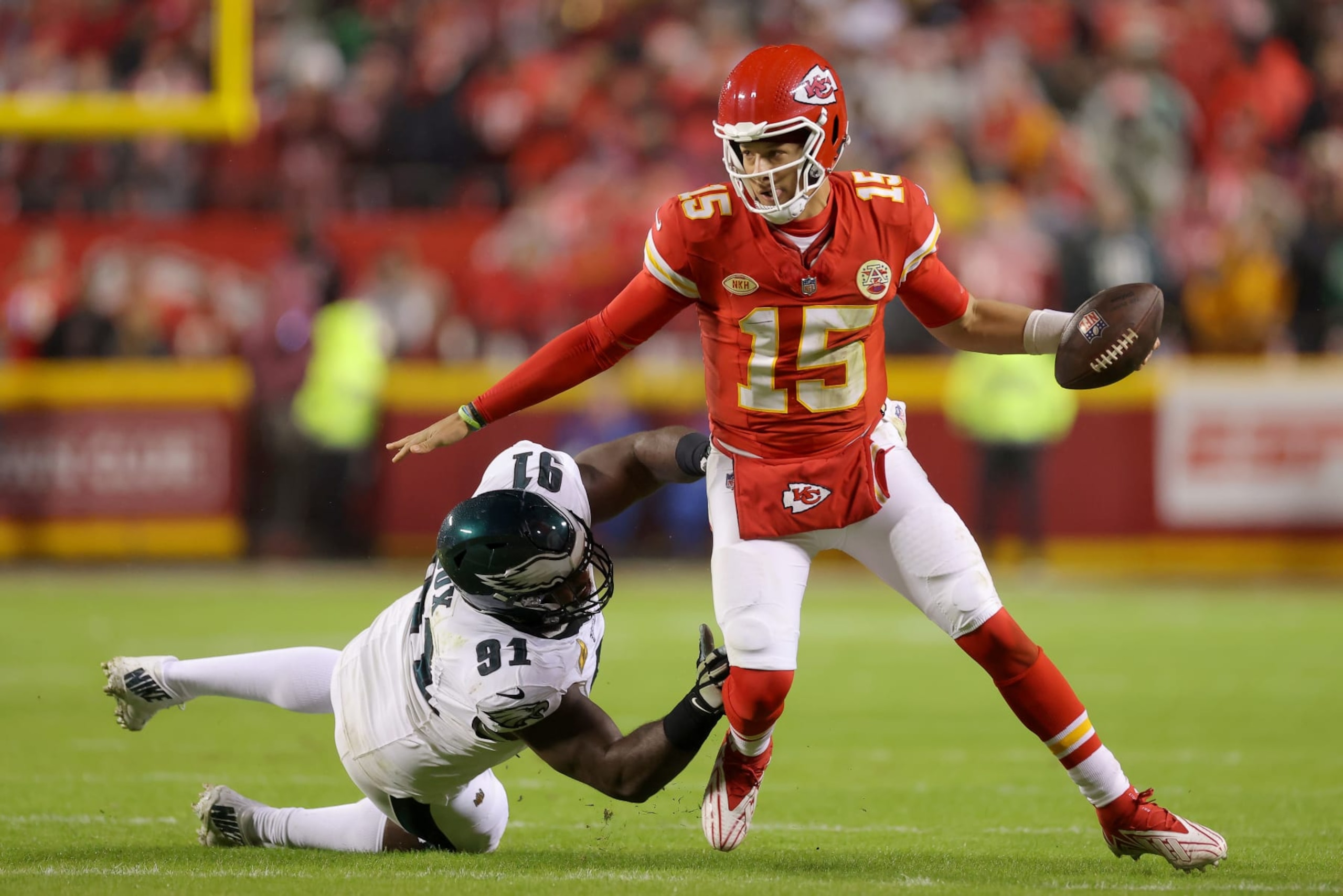 KANSAS CITY, MISSOURI - NOVEMBER 20: Patrick Mahomes #15 of the Kansas City Chiefs gets away from Fletcher Cox #91 of the Philadelphia Eagles in the first half  at GEHA Field at Arrowhead Stadium on November 20, 2023 in Kansas City, Missouri. (Photo by Jamie Squire/Getty Images)