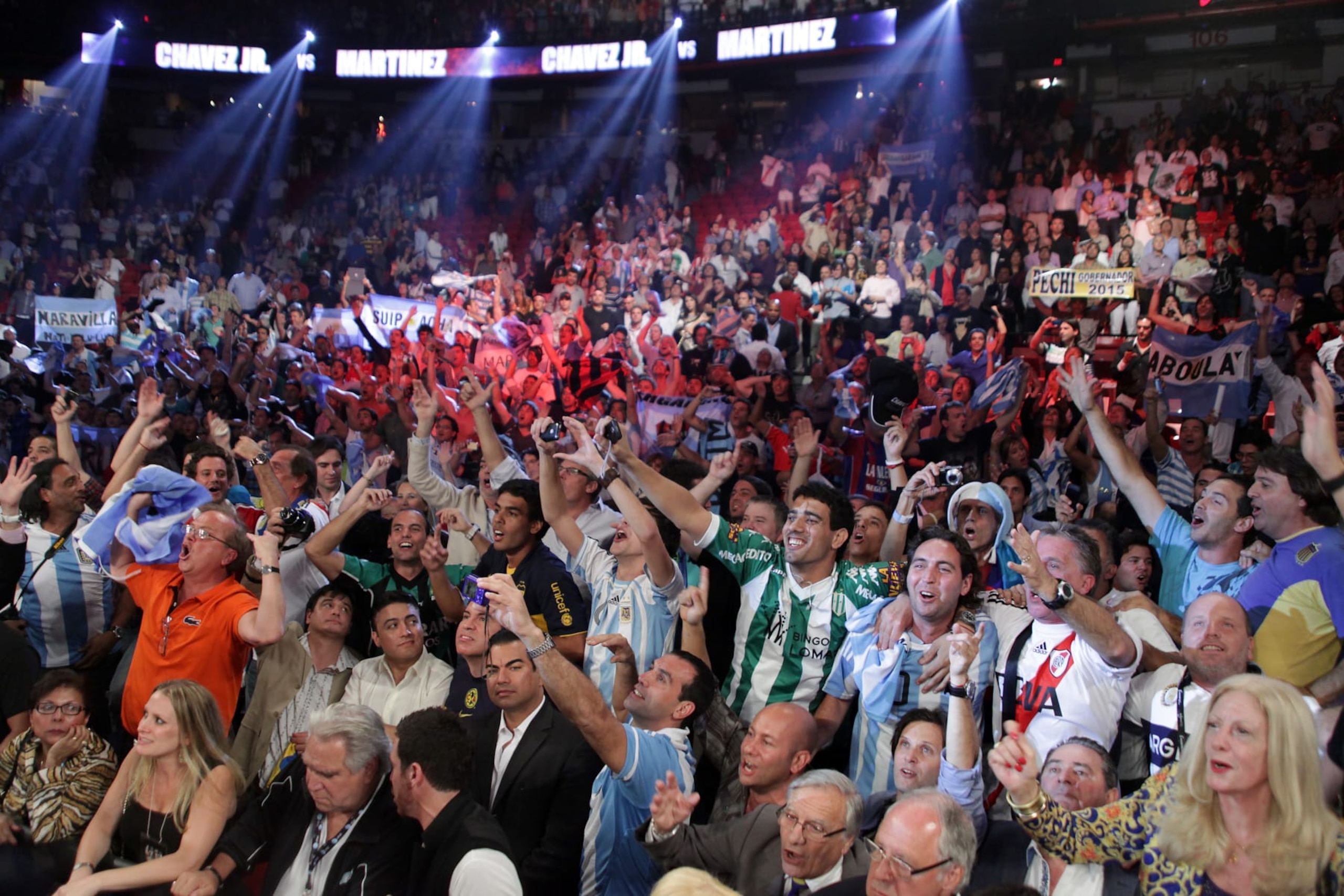 Fans cheers as Sergio Martinez of Argentina celebrates winning the WBC middleweight title with a 12-round unanimous decision over Julio Cesar Chavez Jr. of Mexico Saturday, September 15, 2012 at the Thomas & Mack Center in Las Vegas, Nevada.     AFP PHOTO / John GURZINSKI        (Photo credit should read JOHN GURZINSKI/AFP/GettyImages)