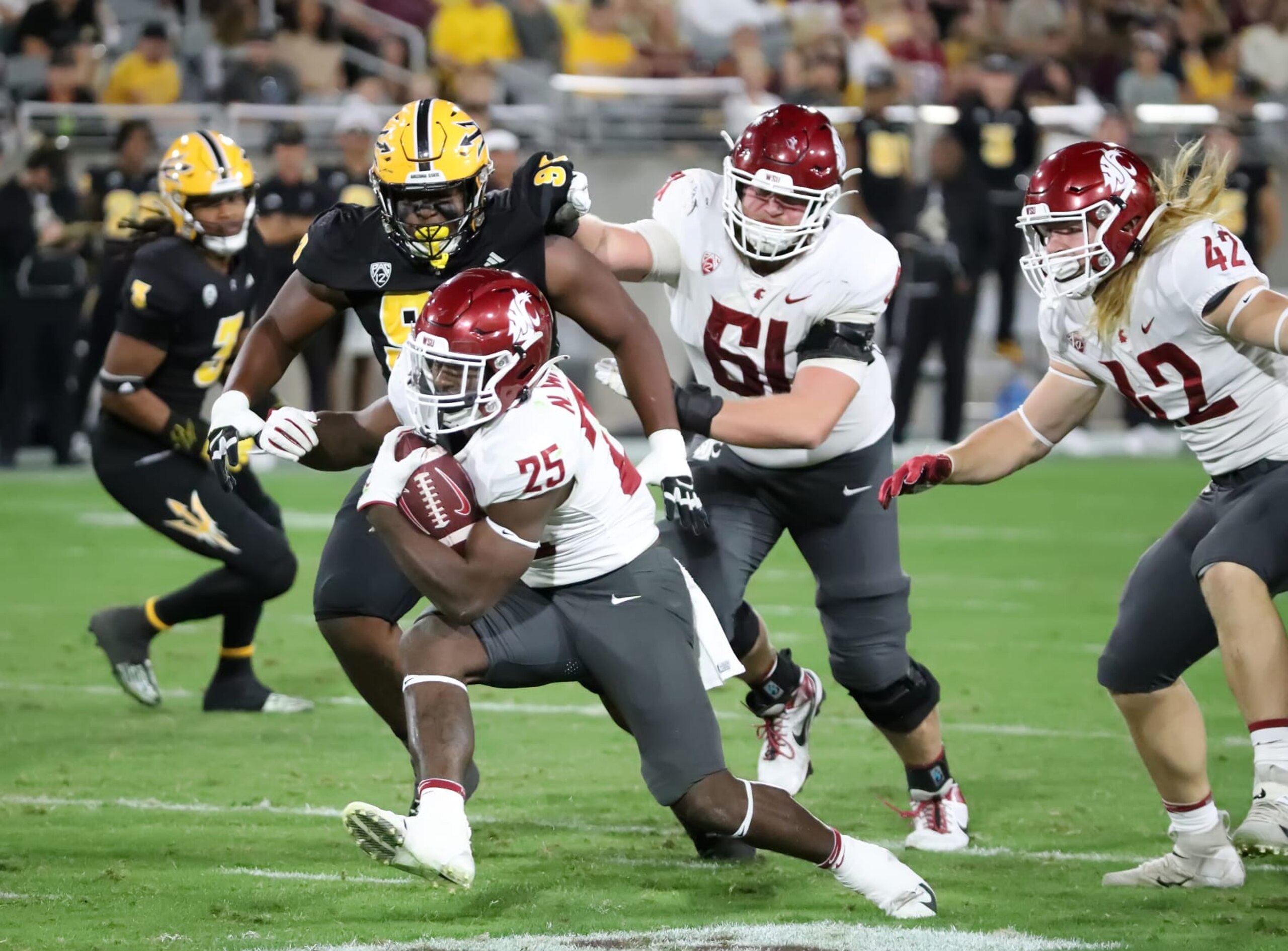 TEMPE, ARIZONA - OCTOBER 28: Nakia Watson #25 of the Washington State Cougars rushes for a first down in the second quarter against the Arizona State Sun Devils at Mountain America Stadium on October 28, 2023 in Tempe, Arizona. (Photo by Bruce Yeung/Getty Images)