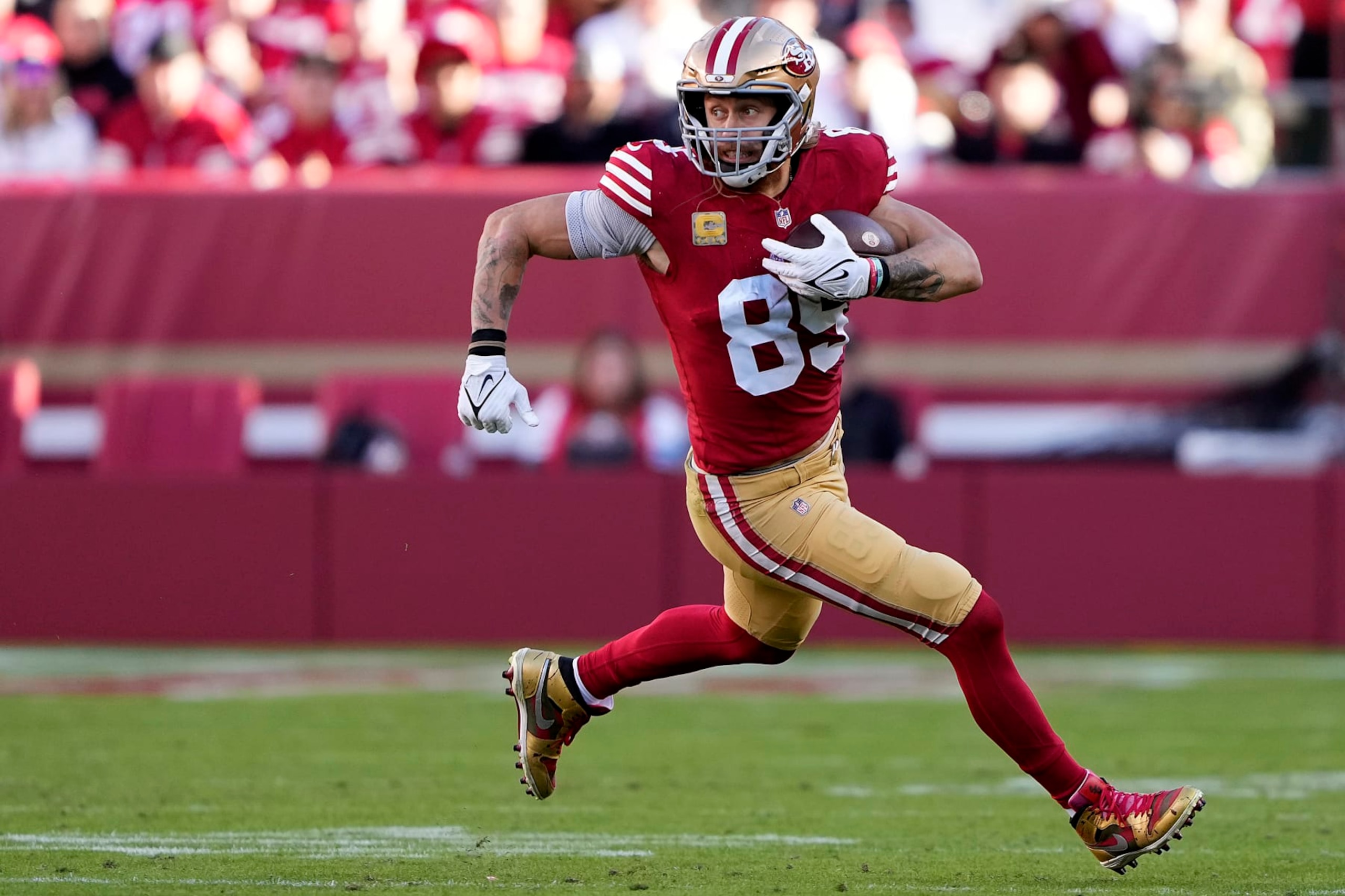 SANTA CLARA, CALIFORNIA - NOVEMBER 19: George Kittle #85 of the San Francisco 49ers runs with the ball during the third quarter of a game against the Tampa Bay Buccaneers at Levi's Stadium on November 19, 2023 in Santa Clara, California. (Photo by Thearon W. Henderson/Getty Images)
