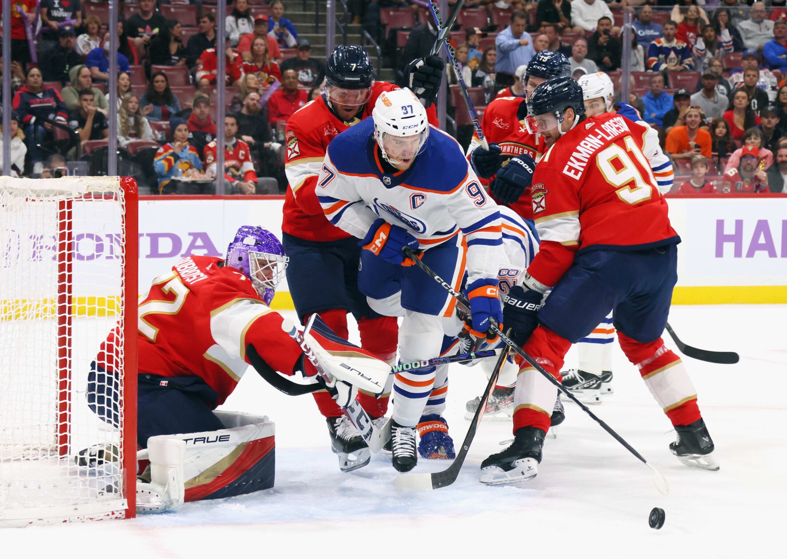 SUNRISE, FLORIDA - NOVEMBER 20: The Florida Panthers converge to stop Connor McDavid #97 of the Edmonton Oilers during the first period at Amerant Bank Arena on November 20, 2023 in Sunrise, Florida. (Photo by Bruce Bennett/Getty Images)