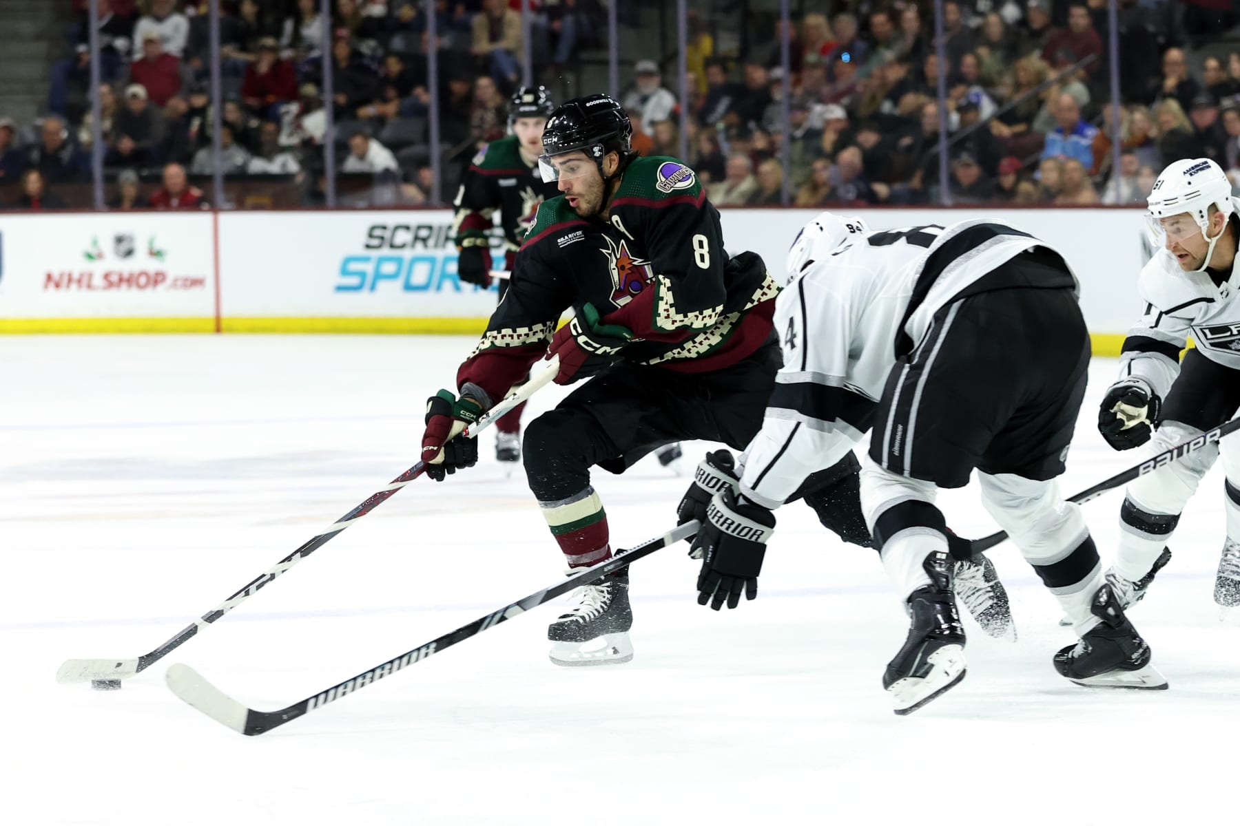 TEMPE, AZ - NOVEMBER 20: Arizona Coyotes center Nick Schmaltz (8) skates with the puck agaisnt Los Angeles Kings defenseman Vladislav Gavrikov (84) during the second period of a hockey game between the Los Angeles Kings and the Arizona Coyotes on November 20, 2023, at Mullett Arena in Tempe, AZ. (Photo by Zac BonDurant/Icon Sportswire via Getty Images) TEMPE, AZ - NOVEMBER 20: Arizona Coyotes center Nick Schmaltz (8) skates with the puck agaisnt Los Angeles Kings defenseman Vladislav Gavrikov (84) during the second period of a hockey game between the Los Angeles Kings and the Arizona Coyotes on November 20, 2023, at Mullett Arena in Tempe, AZ. (Photo by Zac BonDurant/Icon Sportswire via Getty Images)