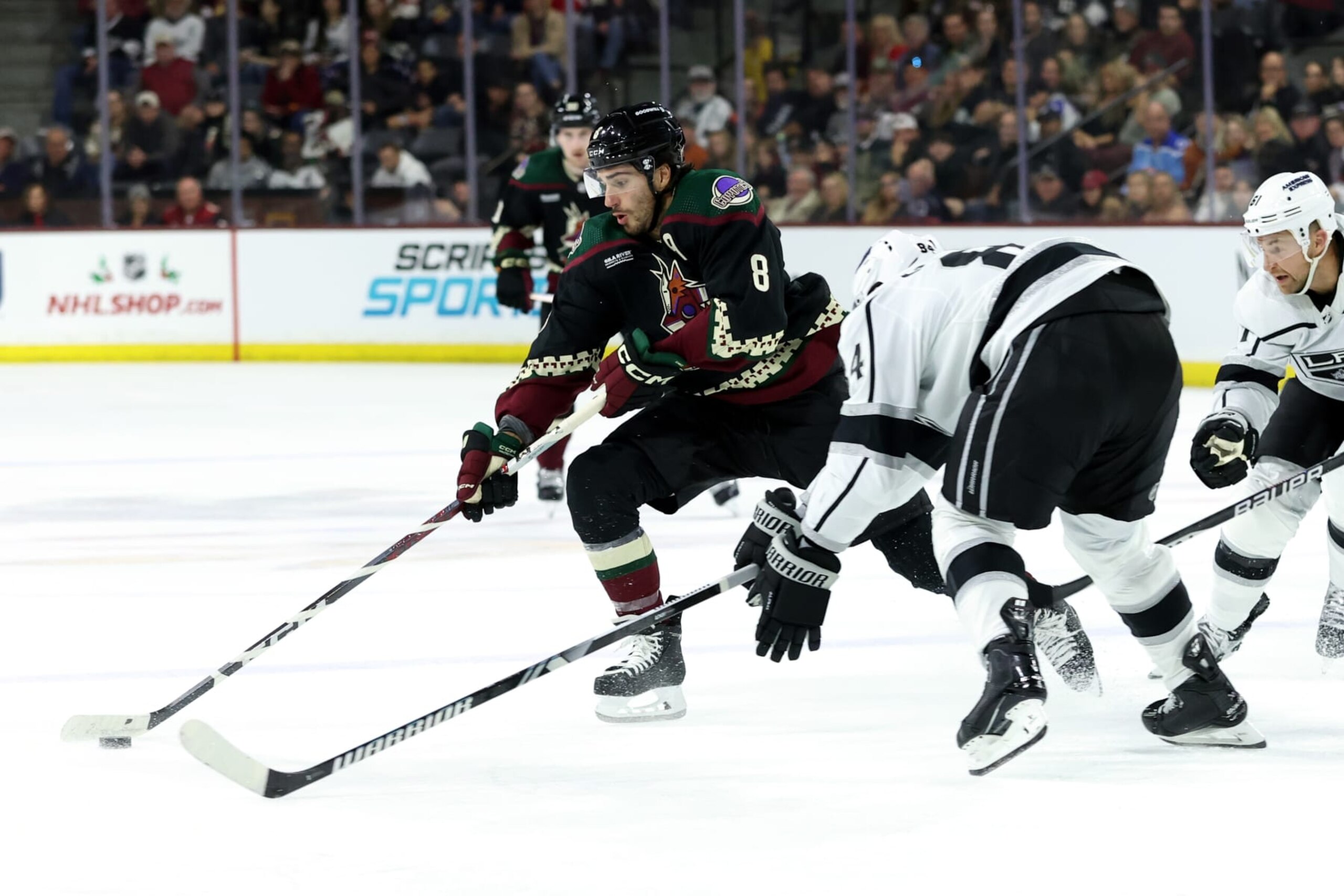 TEMPE, AZ - NOVEMBER 20: Arizona Coyotes center Nick Schmaltz (8) skates with the puck agaisnt Los Angeles Kings defenseman Vladislav Gavrikov (84) during the second period of a hockey game between the Los Angeles Kings and the Arizona Coyotes on November 20, 2023, at Mullett Arena in Tempe, AZ. (Photo by Zac BonDurant/Icon Sportswire via Getty Images)