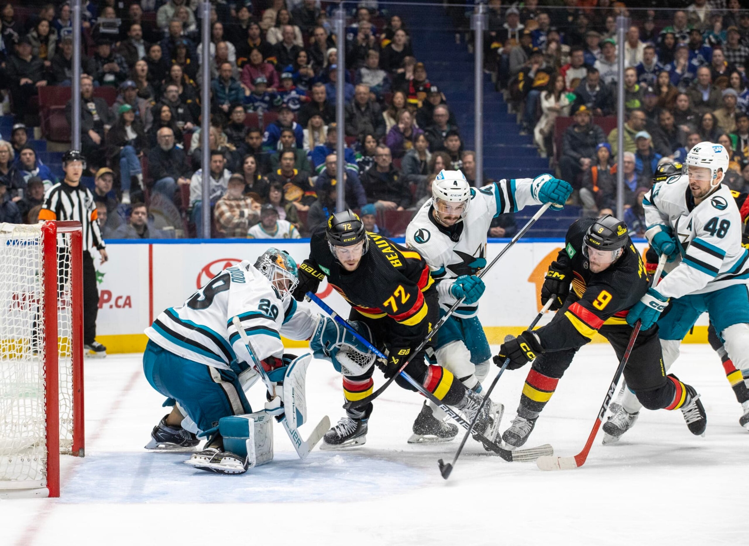 VANCOUVER, CANADA - NOVEMBER 20:  J.T. Miller #9 of the Vancouver Canucks scores a goal on  Mackenzie Blackwood #29 of the San Jose Sharks in the third period of their NHL game at Rogers Arena on November 20, 2023 in Vancouver, British Columbia, Canada.  (Photo by Jeff Vinnick/NHLI via Getty Images)