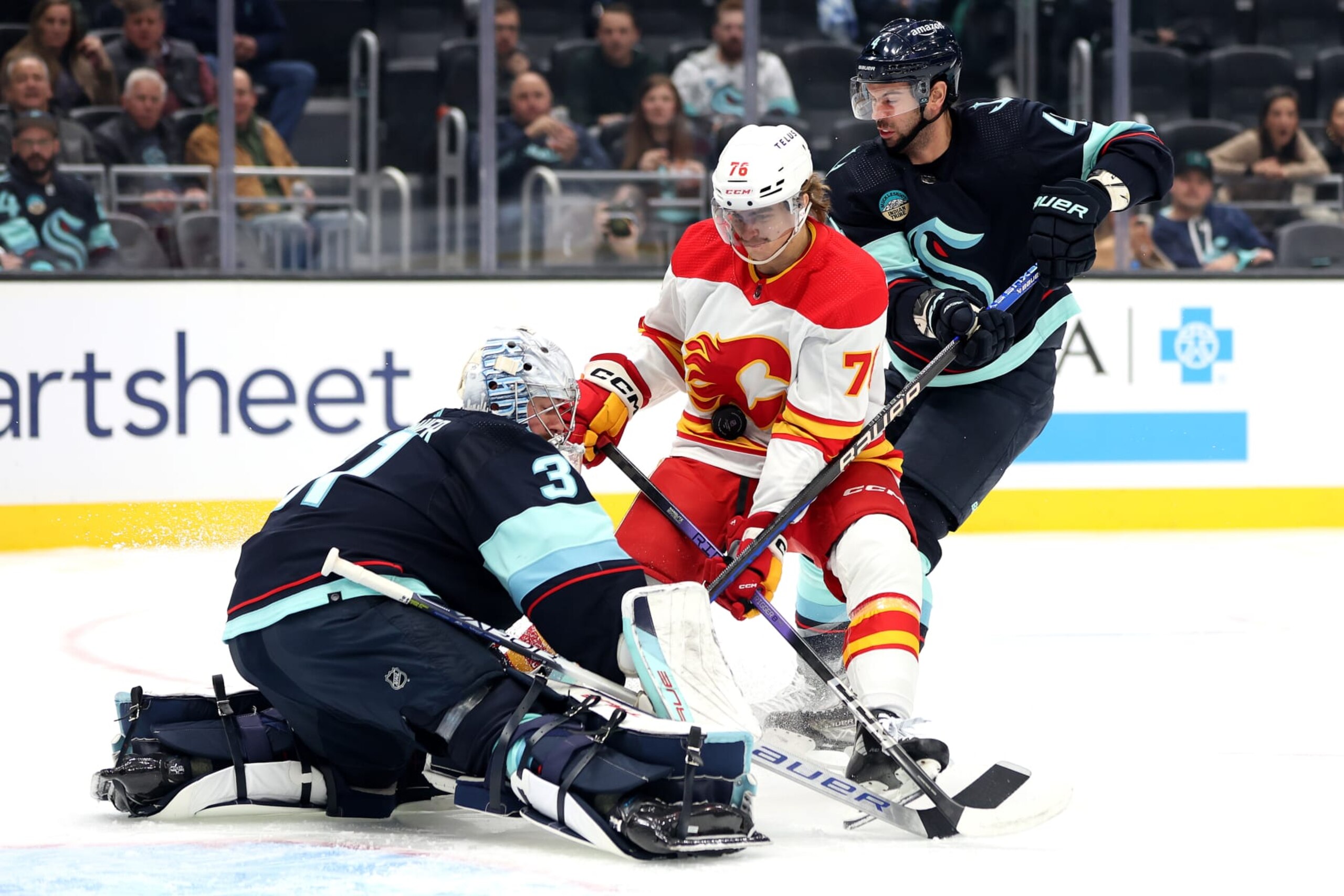 SEATTLE, WASHINGTON - NOVEMBER 20: Martin Pospisil #76 of the Calgary Flames scores a goal, which was later disallowed for goaltender interference, against Philipp Grubauer #31 of the Seattle Kraken during the first period at Climate Pledge Arena on November 20, 2023 in Seattle, Washington. (Photo by Steph Chambers/Getty Images)