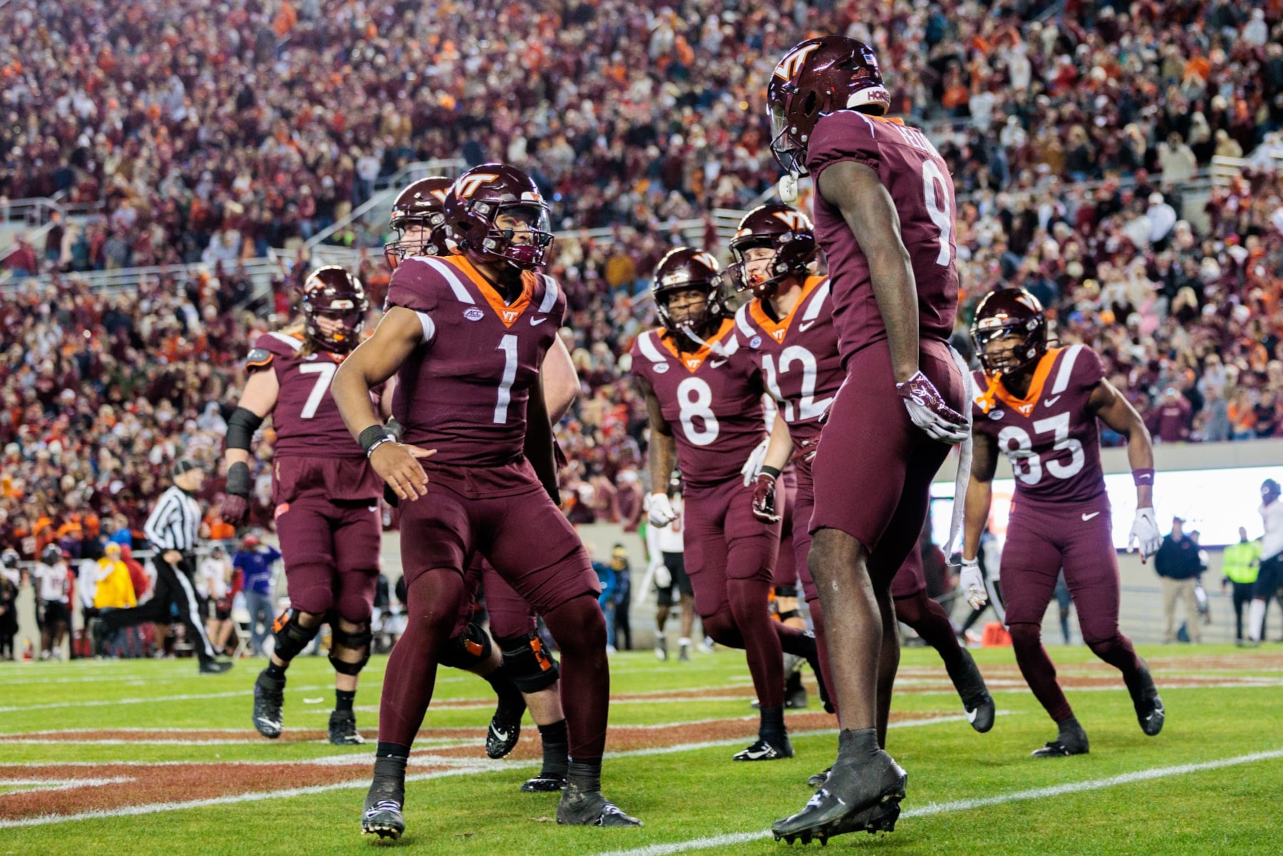 BLACKSBURG, VIRGINIA - NOVEMBER 18: Kyron Drones #1 and Da'Quan Felton #9 of the Virginia Tech Hokies react after a touchdown against the NC State Wolfpack in the second half during a game at Lane Stadium on November 18, 2023 in Blacksburg, Virginia. (Photo by Ryan Hunt/Getty Images) BLACKSBURG, VIRGINIA - NOVEMBER 18: Kyron Drones #1 and Da'Quan Felton #9 of the Virginia Tech Hokies react after a touchdown against the NC State Wolfpack in the second half during a game at Lane Stadium on November 18, 2023 in Blacksburg, Virginia. (Photo by Ryan Hunt/Getty Images)