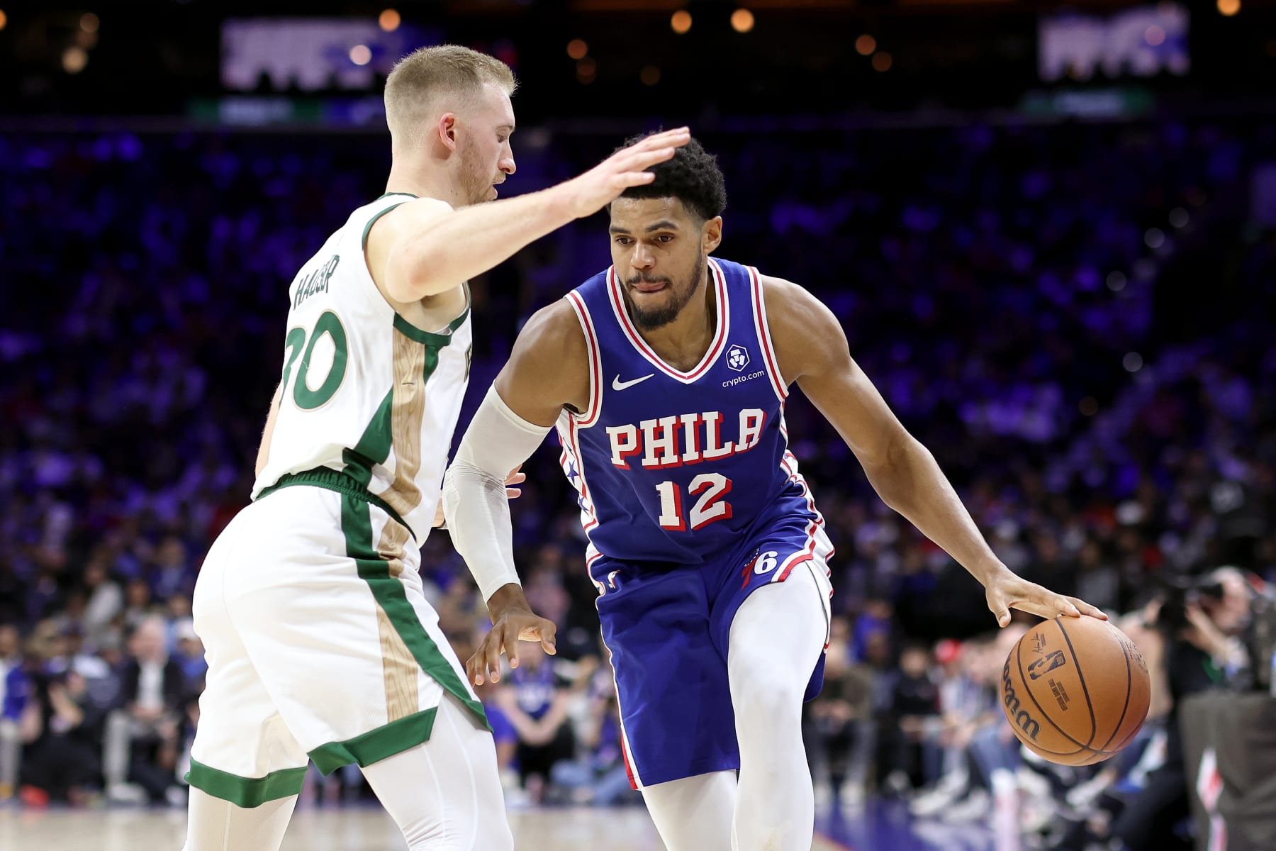 PHILADELPHIA, PENNSYLVANIA - NOVEMBER 15: Tobias Harris #12 of the Philadelphia 76ers dribbles by Sam Hauser #30 of the Boston Celtics during the second quarter at the Wells Fargo Center on November 15, 2023 in Philadelphia, Pennsylvania. NOTE TO USER: User expressly acknowledges and agrees that, by downloading and or using this photograph, User is consenting to the terms and conditions of the Getty Images License Agreement. (Photo by Tim Nwachukwu/Getty Images)