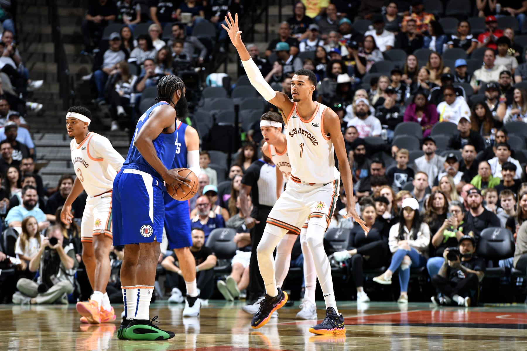SAN ANTONIO, TX - NOVEMBER 20: James Harden #1 of the LA Clippers handles the ball while Victor Wembanyama #1 of the San Antonio Spurs plays defense during the game on November 20, 2023 at the Frost Bank Center in San Antonio, Texas. NOTE TO USER: User expressly acknowledges and agrees that, by downloading and or using this photograph, user is consenting to the terms and conditions of the Getty Images License Agreement. Mandatory Copyright Notice: Copyright 2023 NBAE (Photos by Logan Riely/NBAE via Getty Images)