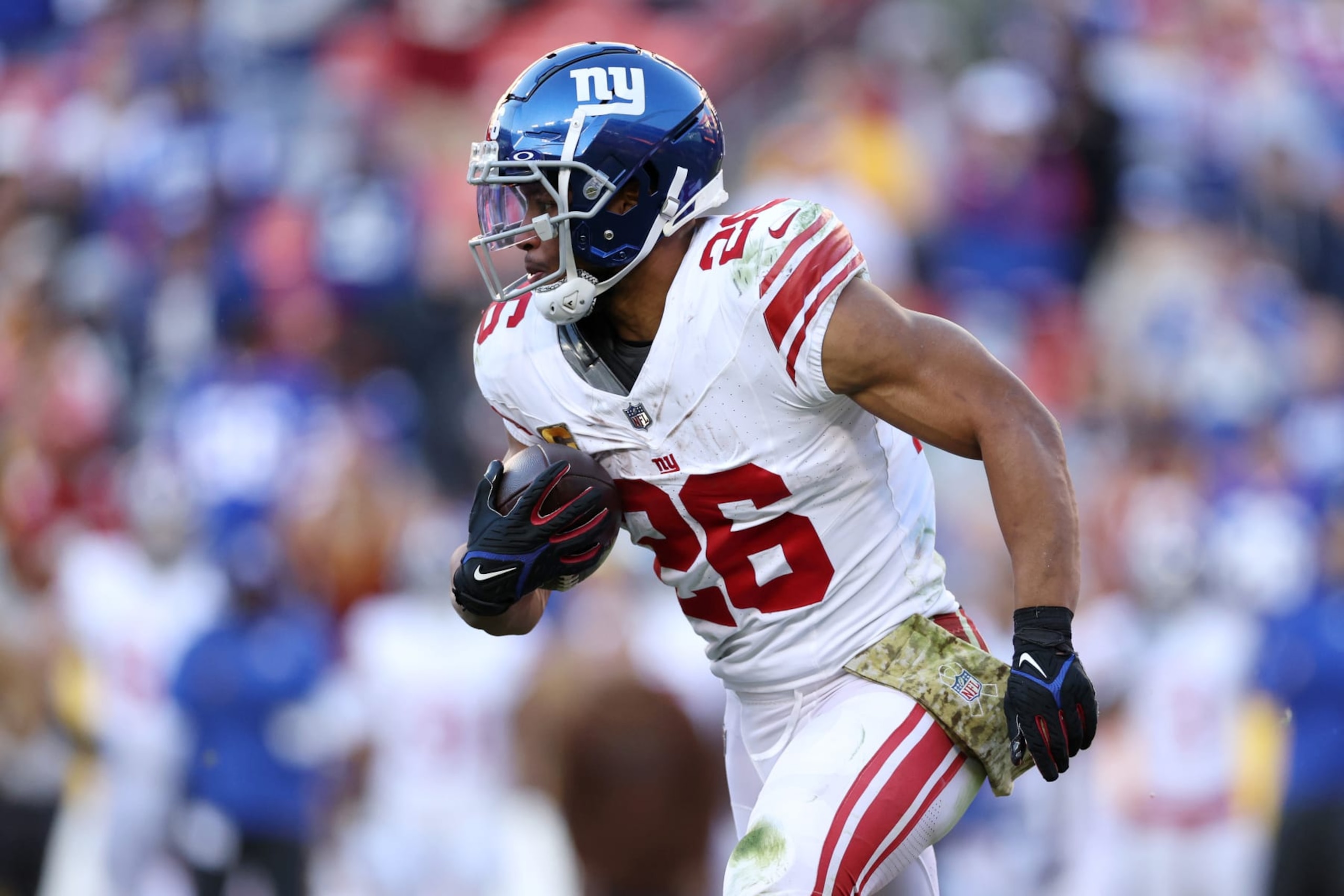 LANDOVER, MARYLAND - NOVEMBER 19: Saquon Barkley #26 of the New York Giants runs the ball during the second half against the Washington Commanders at FedExField on November 19, 2023 in Landover, Maryland. (Photo by Patrick Smith/Getty Images)