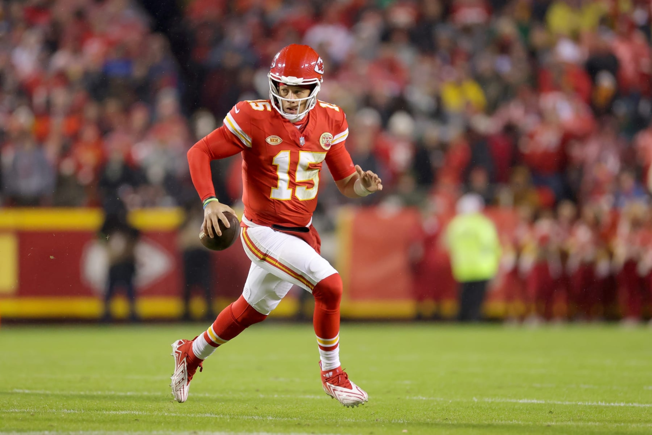 KANSAS CITY, MISSOURI - NOVEMBER 20: Patrick Mahomes #15 of the Kansas City Chiefs scrambles with the ball against the Philadelphia Eagles in the first half  at GEHA Field at Arrowhead Stadium on November 20, 2023 in Kansas City, Missouri. (Photo by Jamie Squire/Getty Images)