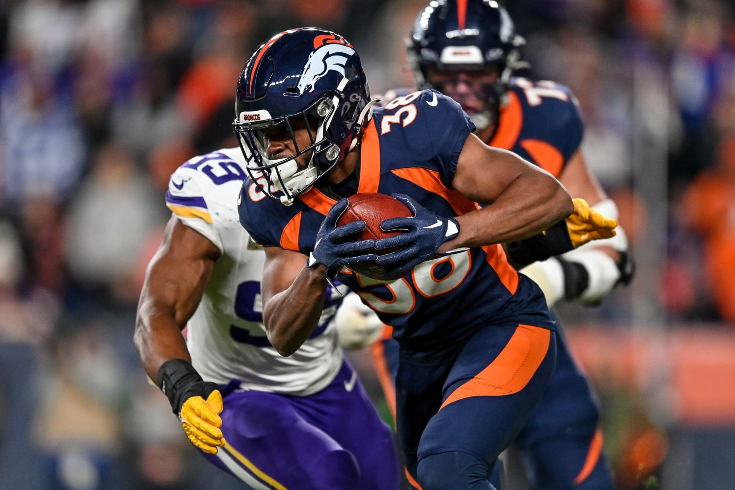 DENVER, COLORADO - NOVEMBER 19:  Jaleel McLaughlin #38 of the Denver Broncos carries the ball against the Minnesota Vikings in the third quarter at Empower Field at Mile High on November 19, 2023 in Denver, Colorado. (Photo by Dustin Bradford/Getty Images)