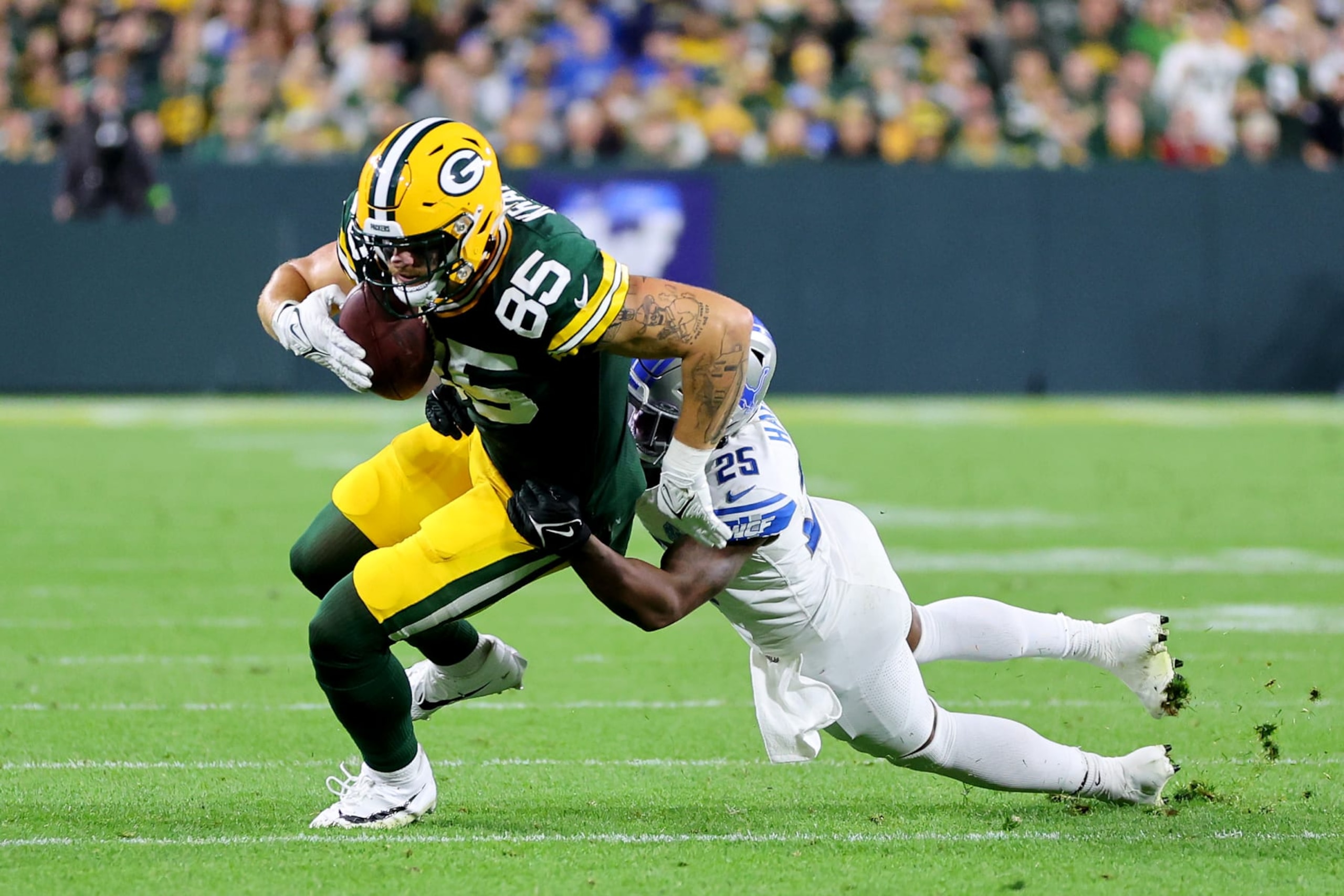 GREEN BAY, WISCONSIN - SEPTEMBER 28: Will Harris #25 of the Detroit Lions tackles Tucker Kraft #85 of the Green Bay Packers during the third quarter in the game at Lambeau Field on September 28, 2023 in Green Bay, Wisconsin. (Photo by Stacy Revere/Getty Images) GREEN BAY, WISCONSIN - SEPTEMBER 28: Will Harris #25 of the Detroit Lions tackles Tucker Kraft #85 of the Green Bay Packers during the third quarter in the game at Lambeau Field on September 28, 2023 in Green Bay, Wisconsin. (Photo by Stacy Revere/Getty Images)