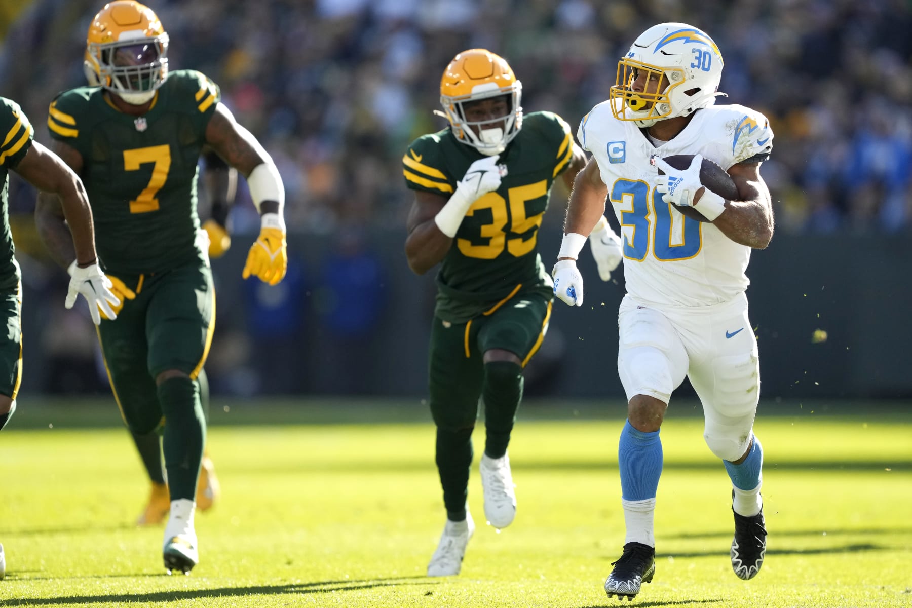 GREEN BAY, WISCONSIN - NOVEMBER 19: Austin Ekeler #30 of the Los Angeles Chargers runs with the ball in the first quarter against the Green Bay Packers at Lambeau Field on November 19, 2023 in Green Bay, Wisconsin. (Photo by Patrick McDermott/Getty Images)