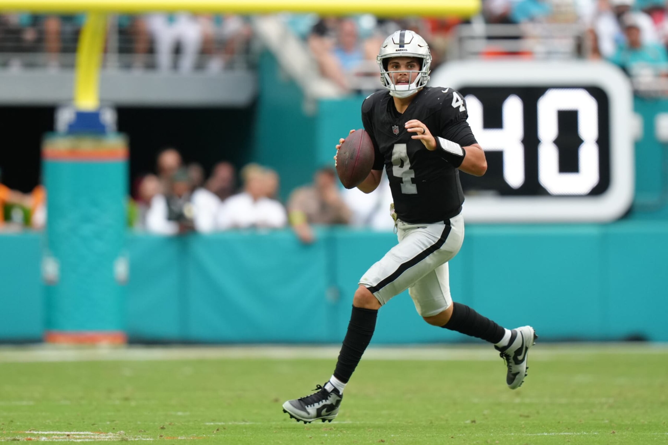 MIAMI GARDENS, FL - NOVEMBER 19: Las Vegas Raiders quarterback Aidan O'Connell (4) looks downfield for a receiver as he scrambles during the game between the Las Vegas Raiders and the Miami Dolphins on Sunday, November 19, 2023 at Hard Rock Stadium, Miami, Fla. (Photo by Peter Joneleit/Icon Sportswire via Getty Images) MIAMI GARDENS, FL - NOVEMBER 19: Las Vegas Raiders quarterback Aidan O'Connell (4) looks downfield for a receiver as he scrambles during the game between the Las Vegas Raiders and the Miami Dolphins on Sunday, November 19, 2023 at Hard Rock Stadium, Miami, Fla. (Photo by Peter Joneleit/Icon Sportswire via Getty Images)