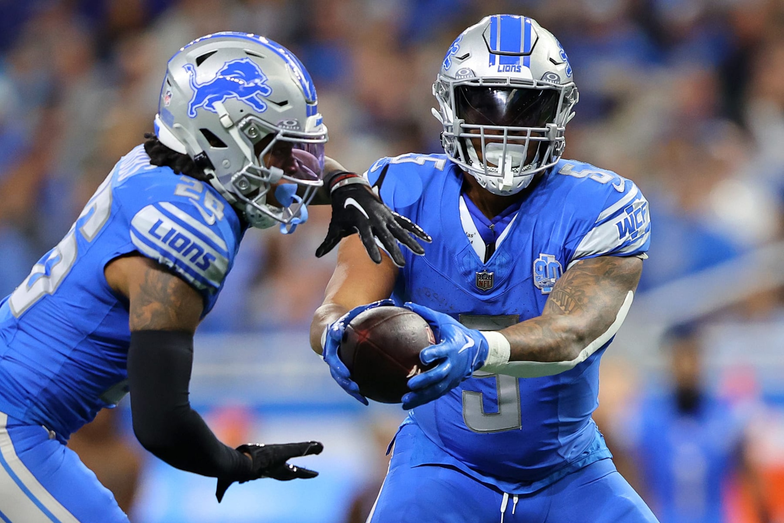 Lions RB David Montgomery hands off to teammate Jahmyr Gibbs in Week 11