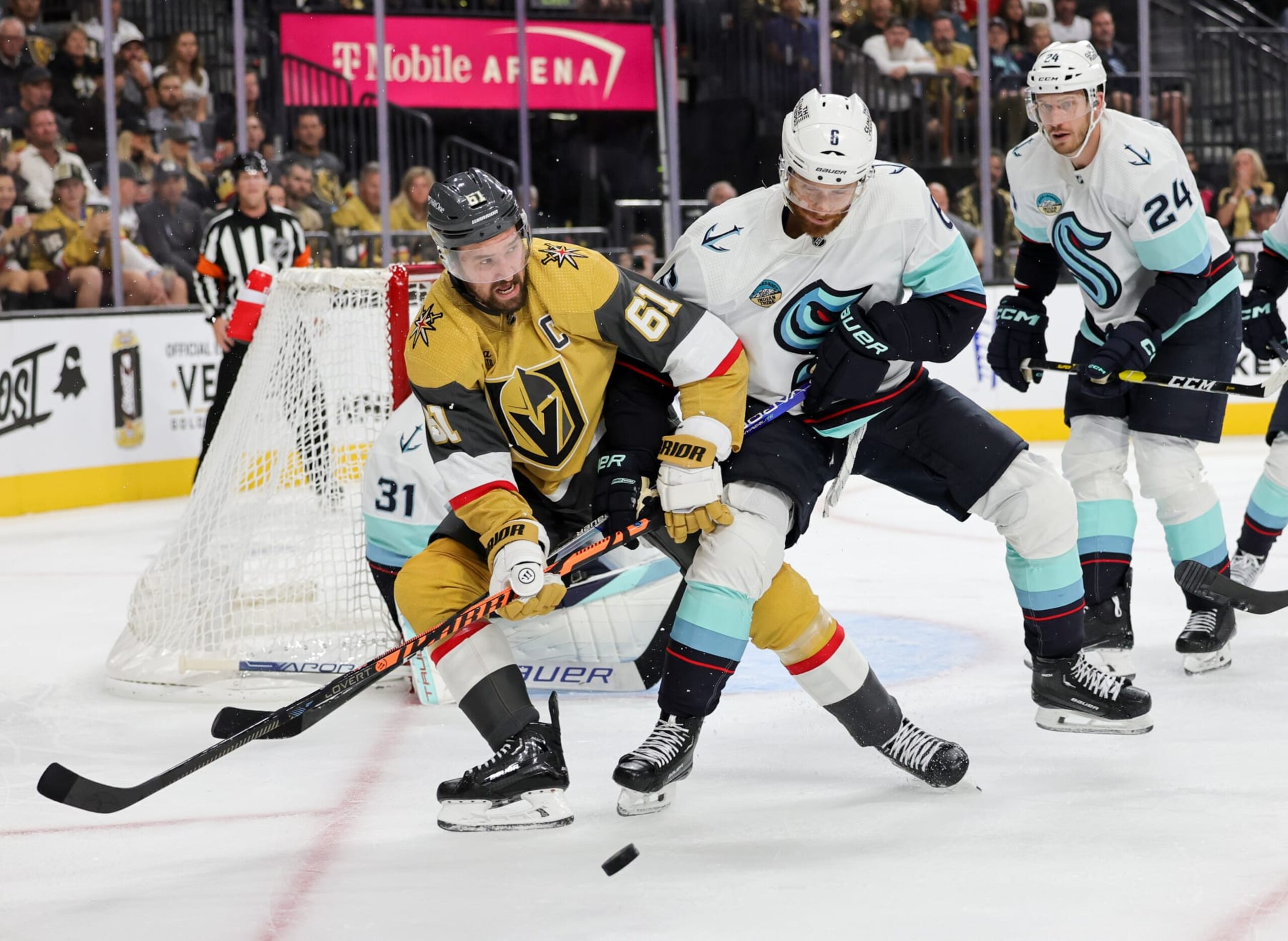 LAS VEGAS, NEVADA - OCTOBER 10: Mark Stone #61 of the Vegas Golden Knights and Adam Larsson #6 of the Seattle Kraken vie for the puck in the second period of their game at T-Mobile Arena on October 10, 2023 in Las Vegas, Nevada. The Golden Knights defeated the Kraken 4-1. (Photo by Ethan Miller/Getty Images)