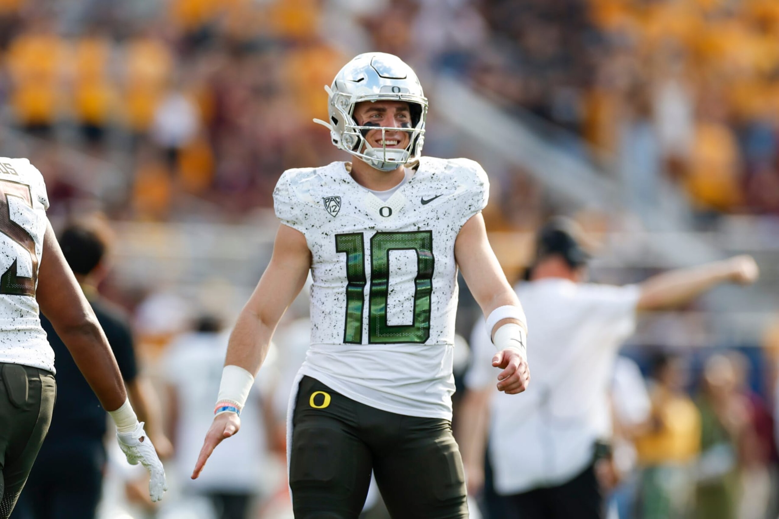 TEMPE, ARIZONA - NOVEMBER 18: Bo Nix #10 of the Oregon Ducks smiles after throwing a touchdown pass in the first quarter during a game against the Arizona State Sun Devils at Mountain America Stadium on November 18, 2023 in Tempe, Arizona. (Photo by Brandon Sloter/Image Of Sport/Getty Images)