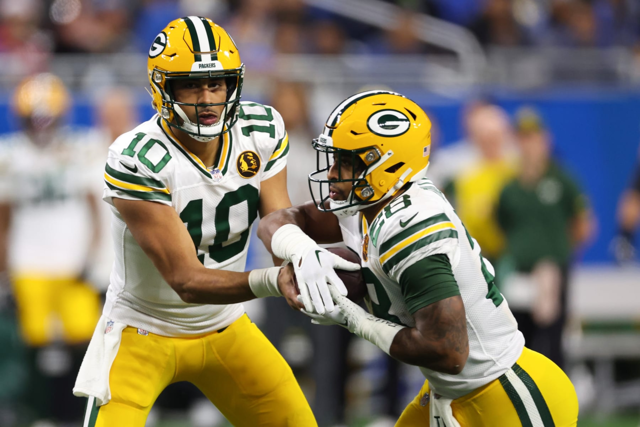 DETROIT, MICHIGAN - NOVEMBER 23: Jordan Love #10 of the Green Bay Packers hands off the ball to AJ Dillon #28 during the first quarter against the Detroit Lions at Ford Field on November 23, 2023 in Detroit, Michigan. (Photo by Gregory Shamus/Getty Images) DETROIT, MICHIGAN - NOVEMBER 23: Jordan Love #10 of the Green Bay Packers hands off the ball to AJ Dillon #28 during the first quarter against the Detroit Lions at Ford Field on November 23, 2023 in Detroit, Michigan. (Photo by Gregory Shamus/Getty Images)