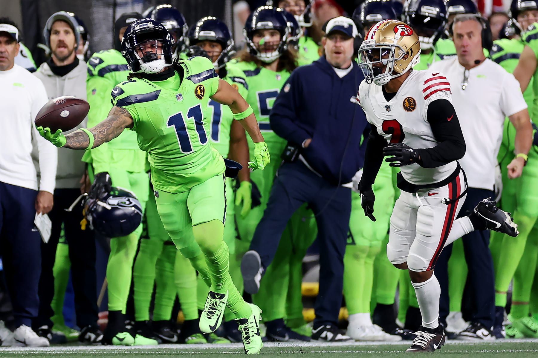 SEATTLE, WASHINGTON - NOVEMBER 23: Jaxon Smith-Njigba #11 of the Seattle Seahawks hauls in a one-handed catch in front of Deommodore Lenoir #2 of the San Francisco 49ers during the third quarter at Lumen Field on November 23, 2023 in Seattle, Washington. (Photo by Steph Chambers/Getty Images)