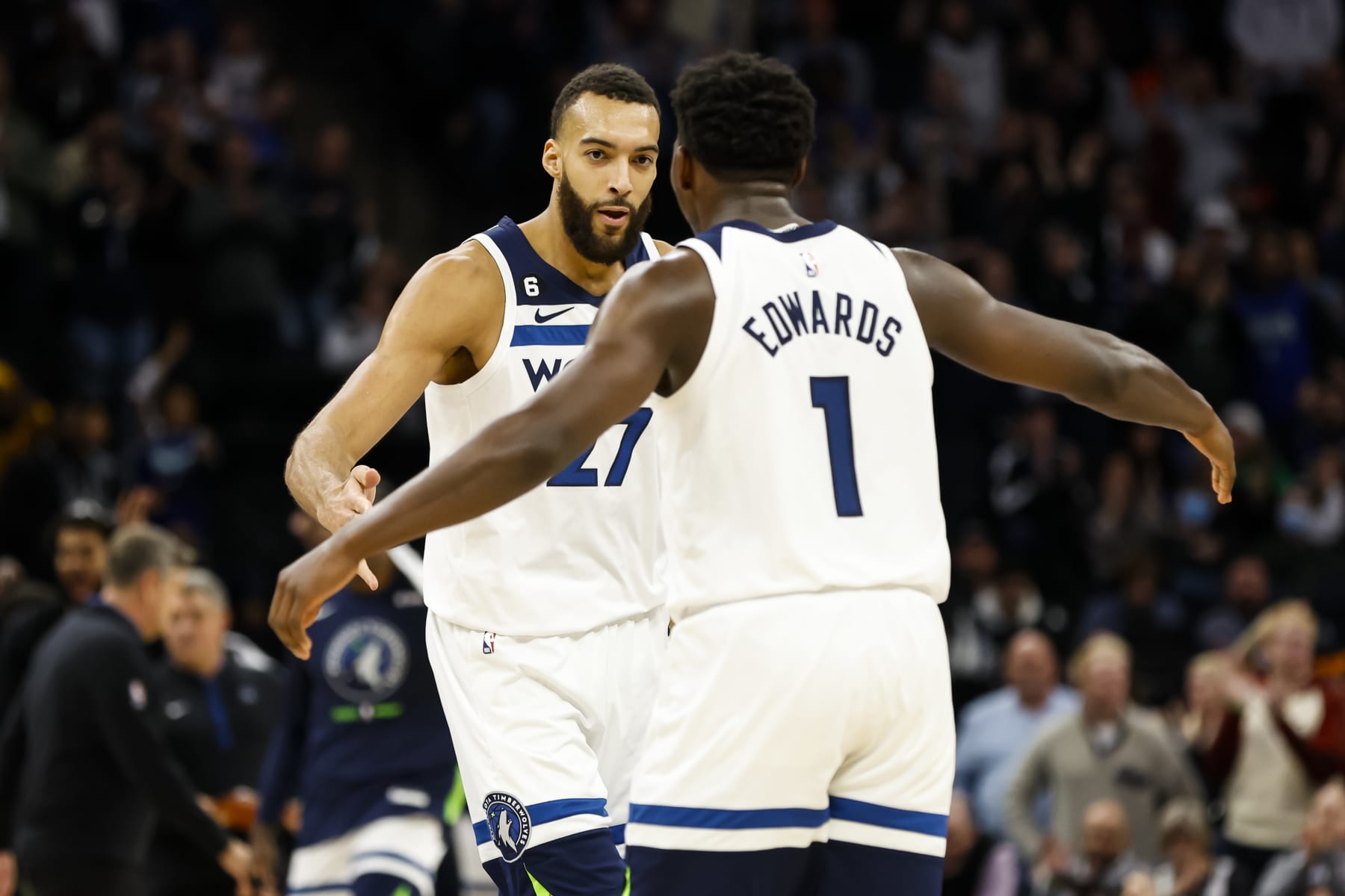 MINNEAPOLIS, MN - JANUARY 02: Rudy Gobert #27 and Anthony Edwards #1 of the Minnesota Timberwolves celebrate a three-point basket by teammate Austin Rivers #25 against the Denver Nuggets in the fourth quarter of the game at Target Center on January 2, 2023 in Minneapolis, Minnesota. The Timberwolves defeated the Nuggets 124-111. NOTE TO USER: User expressly acknowledges and agrees that, by downloading and or using this Photograph, user is consenting to the terms and conditions of the Getty Images License Agreement. (Photo by David Berding/Getty Images)
