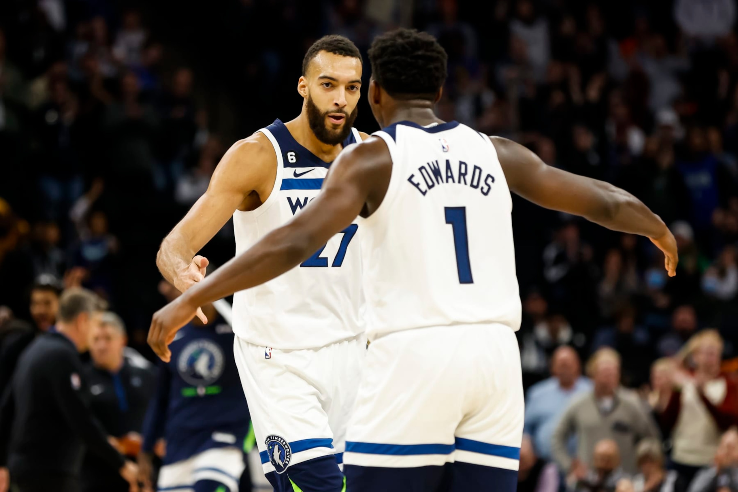 MINNEAPOLIS, MN - JANUARY 02: Rudy Gobert #27 and Anthony Edwards #1 of the Minnesota Timberwolves celebrate a three-point basket by teammate Austin Rivers #25 against the Denver Nuggets in the fourth quarter of the game at Target Center on January 2, 2023 in Minneapolis, Minnesota. The Timberwolves defeated the Nuggets 124-111. NOTE TO USER: User expressly acknowledges and agrees that, by downloading and or using this Photograph, user is consenting to the terms and conditions of the Getty Images License Agreement. (Photo by David Berding/Getty Images)