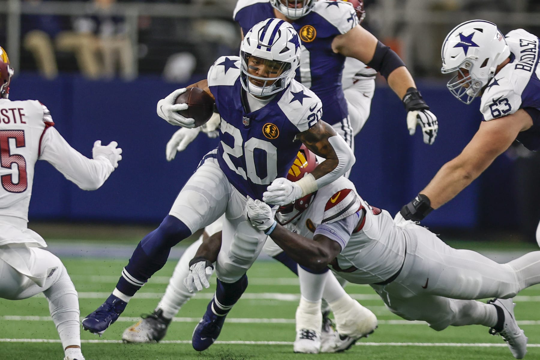 ARLINGTON, TX - NOVEMBER 23: Dallas Cowboys running back Tony Pollard (20) runs through the line of scrimmage during the game between the Dallas Cowboys and the Washington Commanders on November 23, 2023 at AT&T Stadium in Arlington, Texas. (Photo by Matthew Pearce/Icon Sportswire via Getty Images)