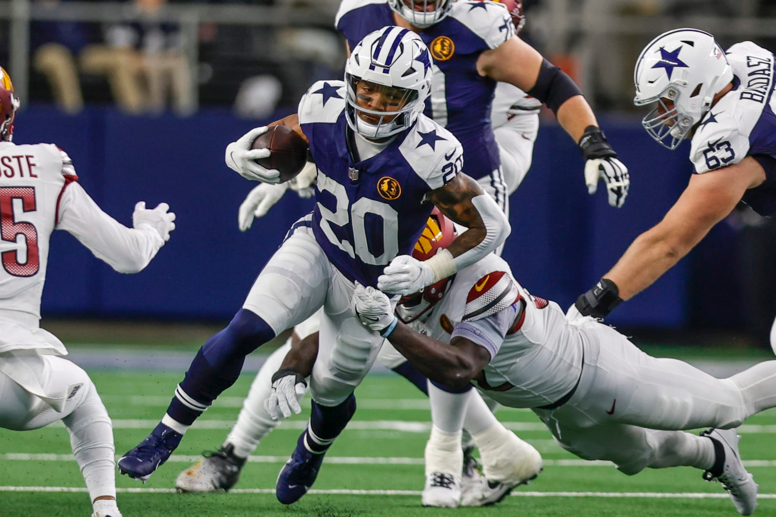 ARLINGTON, TX - NOVEMBER 23: Dallas Cowboys running back Tony Pollard (20) runs through the line of scrimmage during the game between the Dallas Cowboys and the Washington Commanders on November 23, 2023 at AT&T Stadium in Arlington, Texas. (Photo by Matthew Pearce/Icon Sportswire via Getty Images)