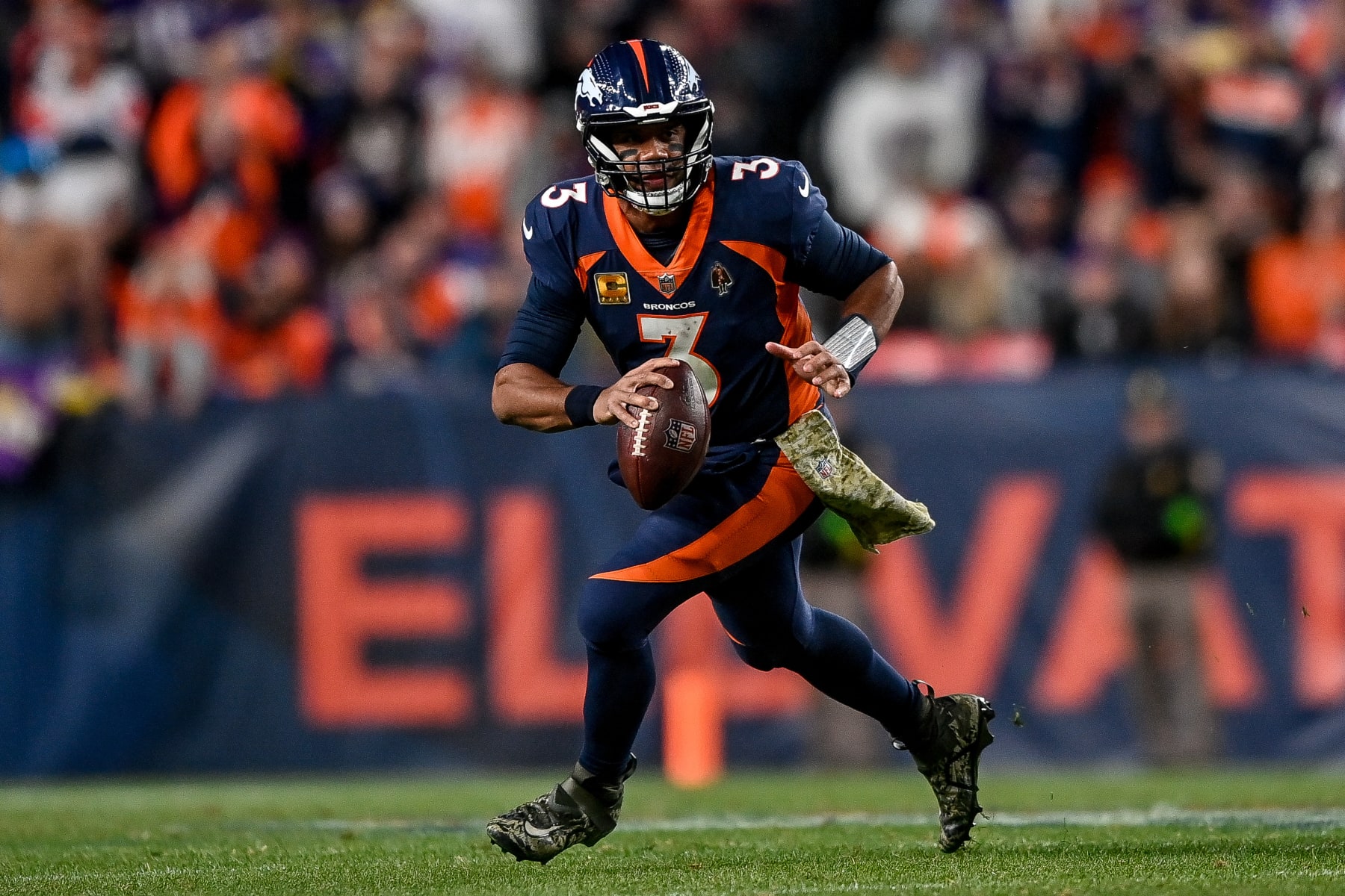 DENVER, COLORADO - NOVEMBER 19:  Russell Wilson #3 of the Denver Broncos searches for a target in the second quarter against the Minnesota Vikings at Empower Field at Mile High on November 19, 2023 in Denver, Colorado. (Photo by Dustin Bradford/Getty Images)
