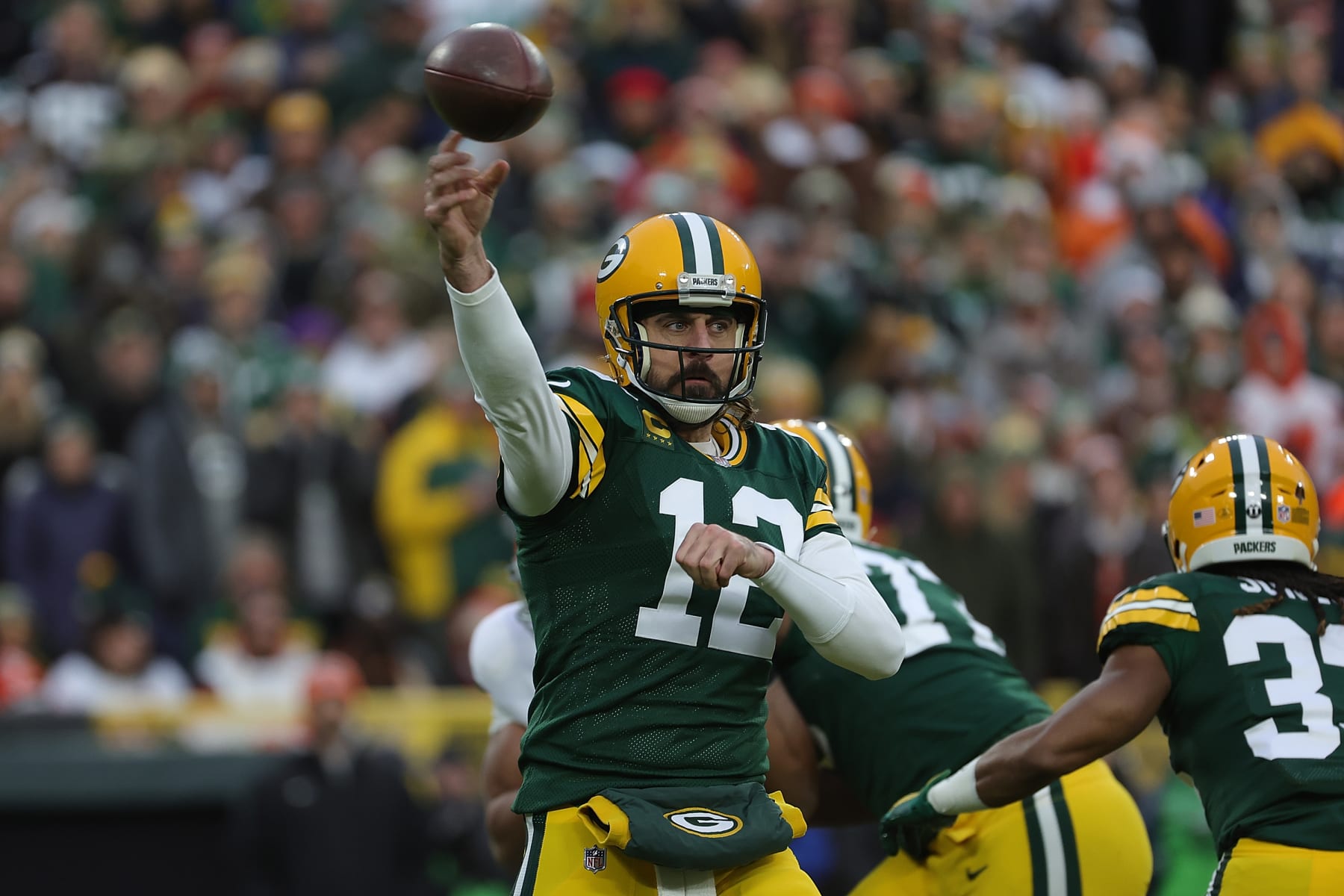GREEN BAY, WISCONSIN - DECEMBER 25: Aaron Rodgers #12 of the Green Bay Packers drops back to pass during a game against the Cleveland Browns at Lambeau Field on December 25, 2021 in Green Bay, Wisconsin.  The Packers defeated the Browns 24-22. (Photo by Stacy Revere/Getty Images)