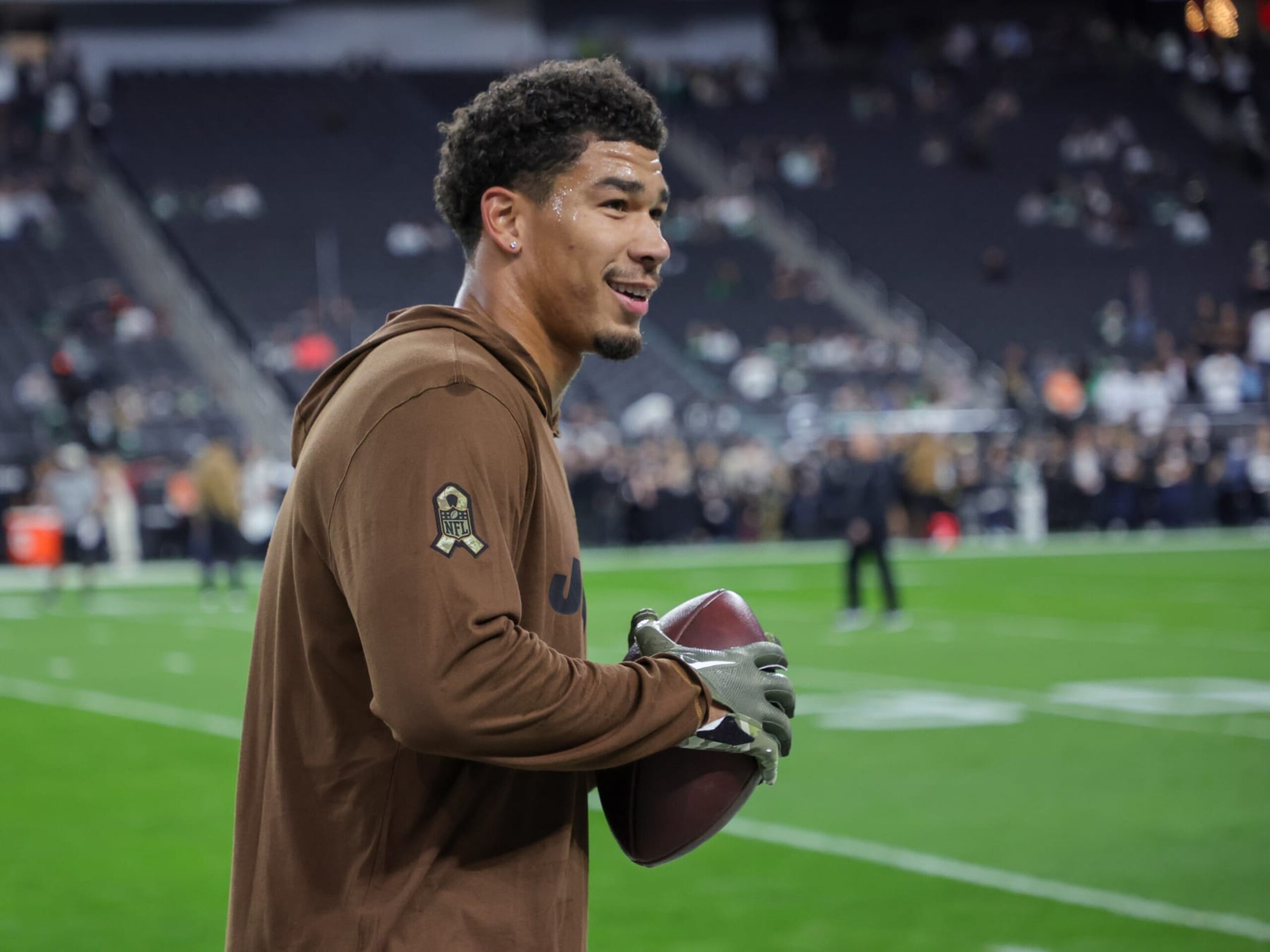 LAS VEGAS, NEVADA - NOVEMBER 12: Wide receiver Allen Lazard #10 of the New York Jets plays catch with fans in the stands before a game against the Las Vegas Raiders at Allegiant Stadium on November 12, 2023 in Las Vegas, Nevada. The Raiders defeated the Jets 16-12. (Photo by Ethan Miller/Getty Images)