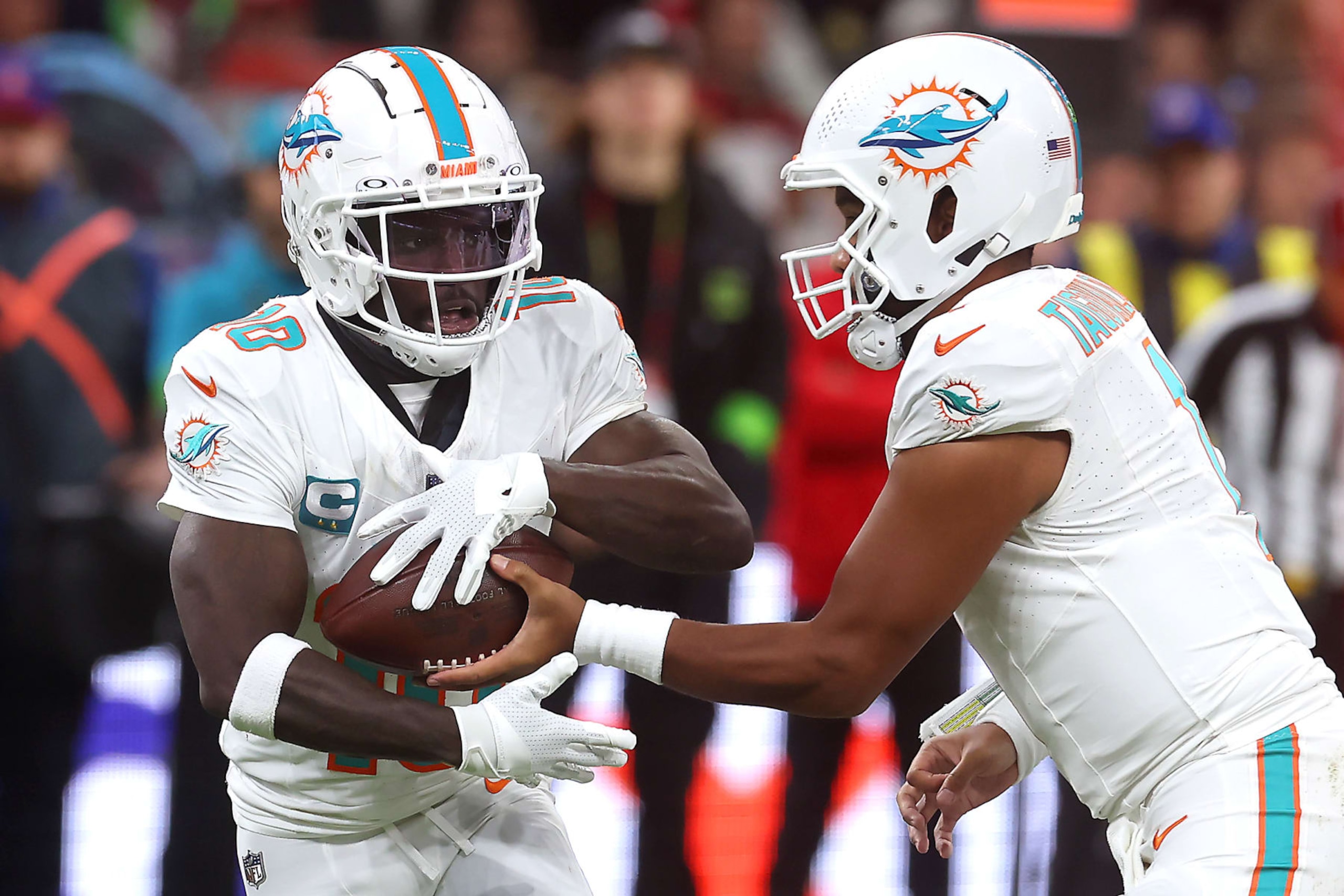 FRANKFURT AM MAIN, GERMANY - NOVEMBER 05: Tua Tagovailoa #1 of the Miami Dolphins hands off to Tyreek Hill #10 of the Miami Dolphins in the first quarter during the NFL match between Miami Dolphins and Kansas City Chiefs at Deutsche Bank Park on November 05, 2023 in Frankfurt am Main, Germany. (Photo by Alex Grimm/Getty Images)