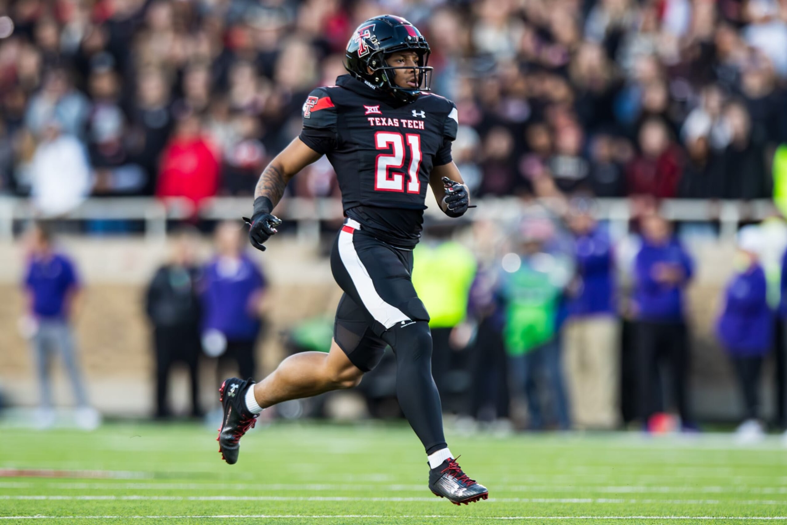 LUBBOCK, TEXAS - OCTOBER 14: Cameron Watts #21 of the Texas Tech Red Raiders runs across the field during the first half of the game against the Kansas State Wildcats at Jones AT&T Stadium on October 14, 2023 in Lubbock, Texas. (Photo by John E. Moore III/Getty Images)