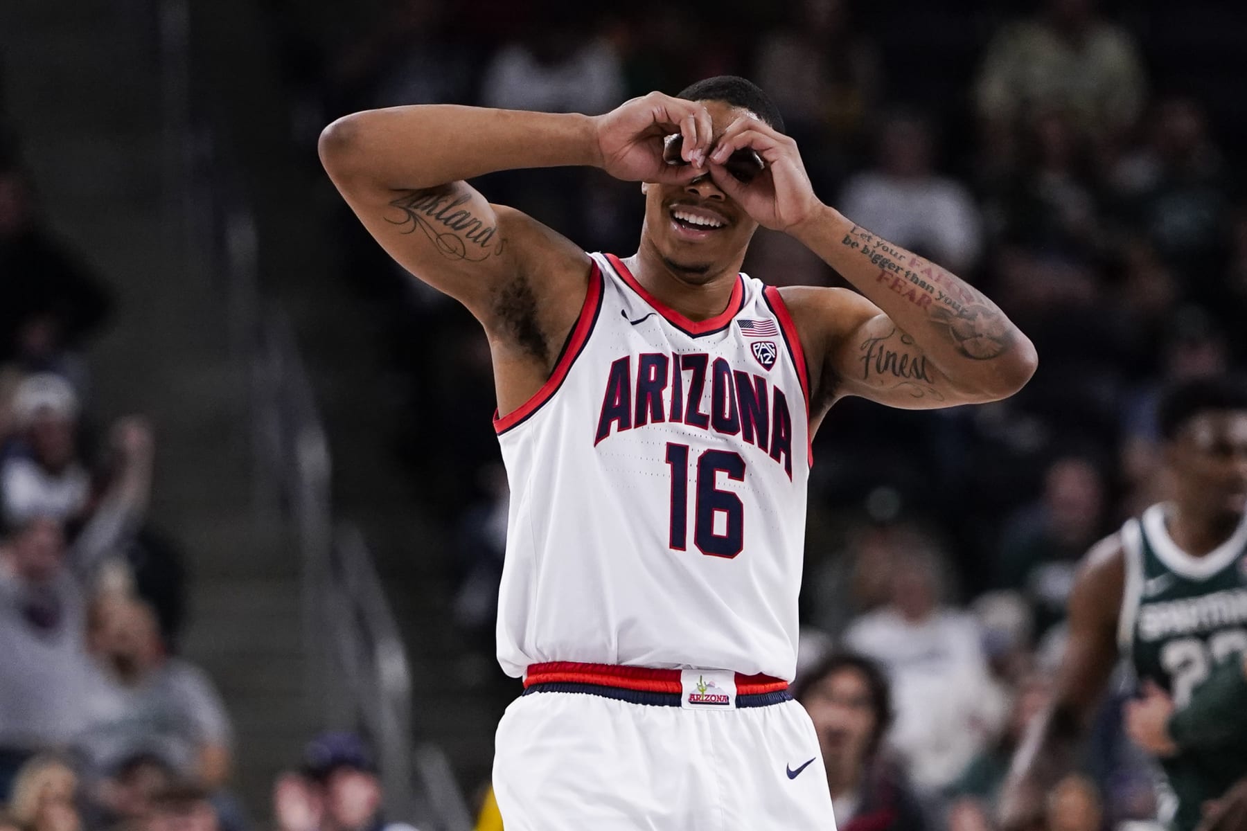 Arizona forward Keshad Johnson reacts during the first half of an NCAA college basketball game against Michigan State, Thursday, Nov. 23, 2023, in Palm Desert, Calif. (AP Photo/Ryan Sun)