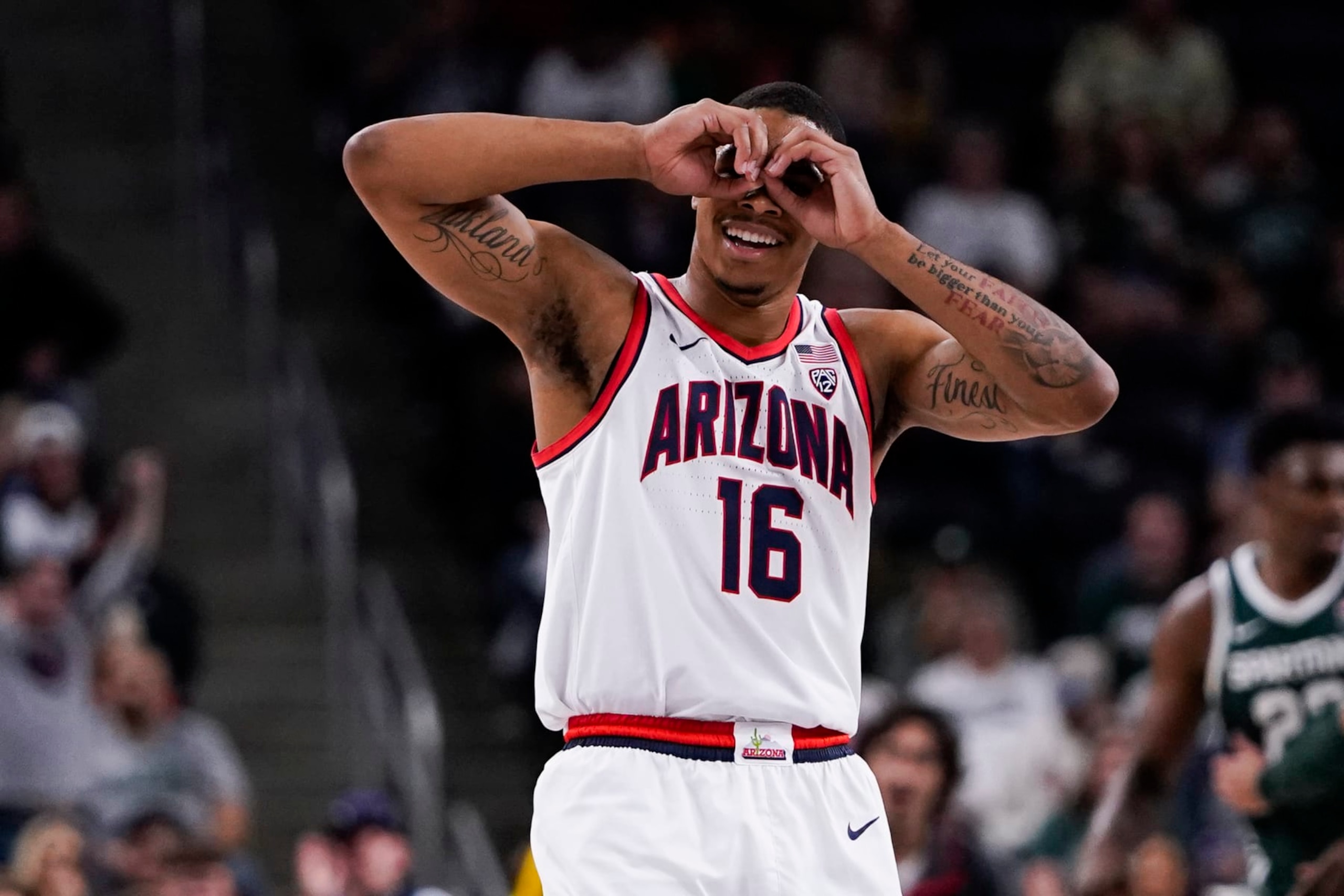Arizona forward Keshad Johnson reacts during the first half of an NCAA college basketball game against Michigan State, Thursday, Nov. 23, 2023, in Palm Desert, Calif. (AP Photo/Ryan Sun)