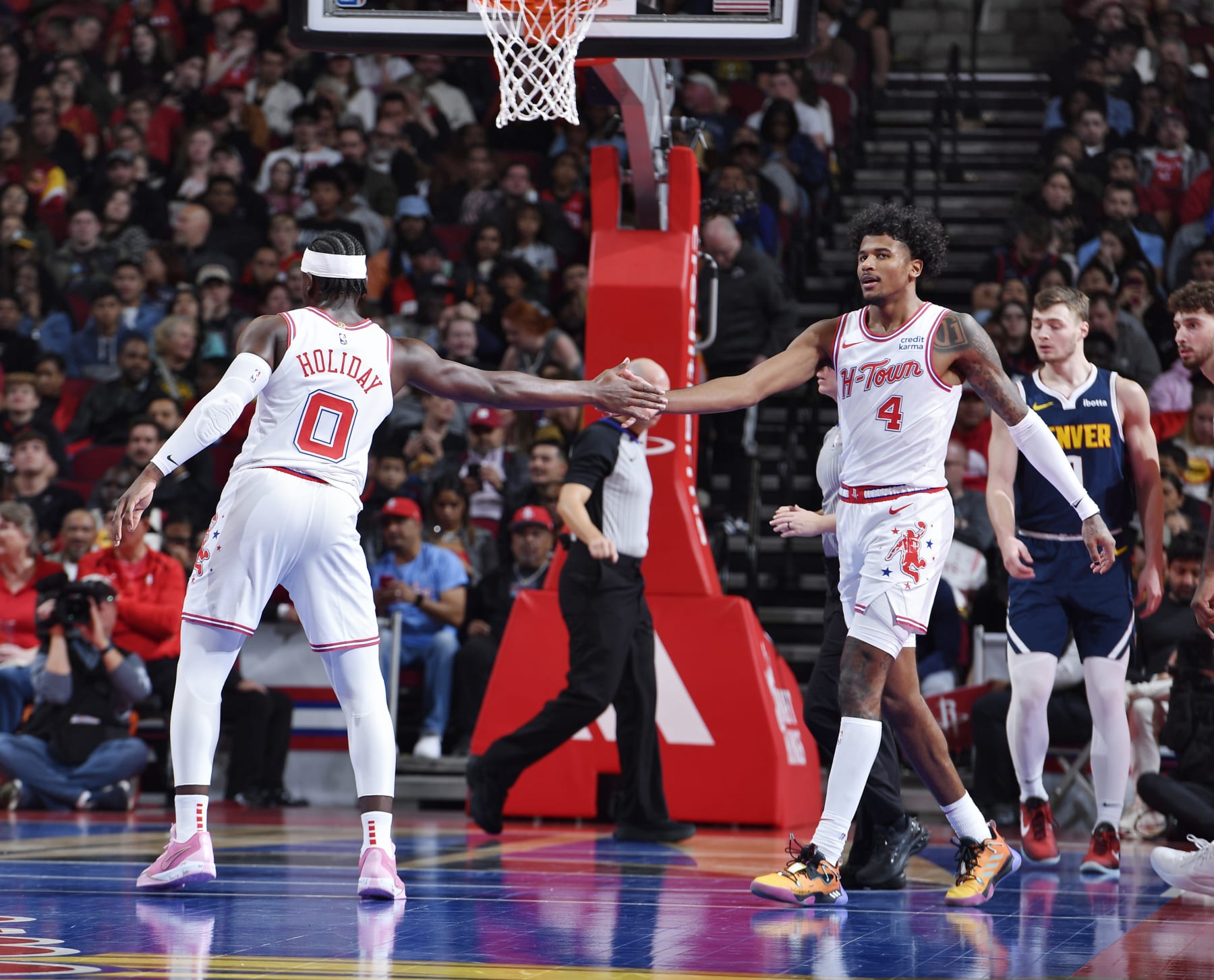 HOUSTON, TX - NOVEMBER 24: Aaron Holiday #0 high fives Jalen Green #4 of the Houston Rockets during the game against the Denver Nuggets during the In-Season Tournament on November 24, 2023 at the Toyota Center in Houston, Texas. NOTE TO USER: User expressly acknowledges and agrees that, by downloading and or using this photograph, User is consenting to the terms and conditions of the Getty Images License Agreement. Mandatory Copyright Notice: Copyright 2023 NBAE (Photo by Logan Riely/NBAE via Getty Images)