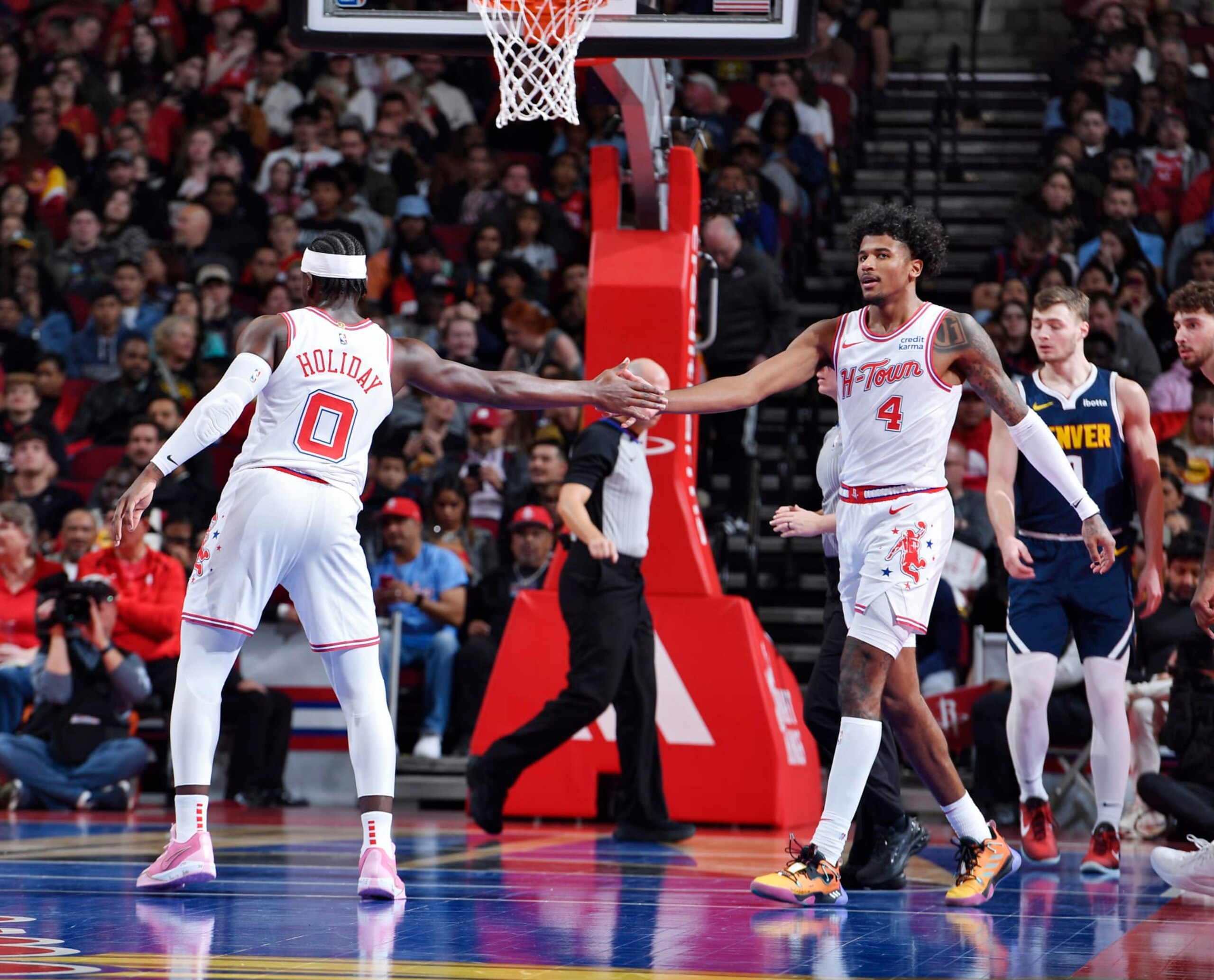 HOUSTON, TX - NOVEMBER 24: Aaron Holiday #0 high fives Jalen Green #4 of the Houston Rockets during the game against the Denver Nuggets during the In-Season Tournament on November 24, 2023 at the Toyota Center in Houston, Texas. NOTE TO USER: User expressly acknowledges and agrees that, by downloading and or using this photograph, User is consenting to the terms and conditions of the Getty Images License Agreement. Mandatory Copyright Notice: Copyright 2023 NBAE (Photo by Logan Riely/NBAE via Getty Images)