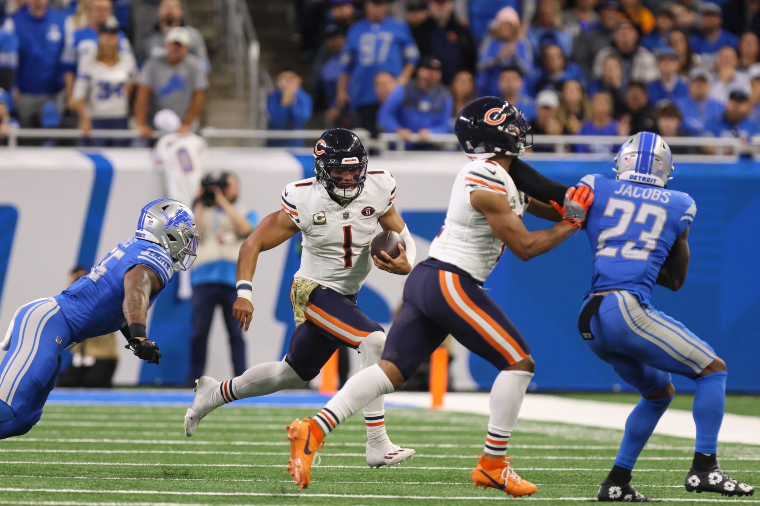 DETROIT, MI - NOVEMBER 19:  Chicago Bears quarterback Justin Fields (1) runs with the ball away from Detroit Lions linebacker Derrick Barnes (55) during an NFL football game between the Chicago Bears and the Detroit Lions on November 19, 2023 at Ford Field in Detroit, Michigan.  (Photo by Scott W. Grau/Icon Sportswire via Getty Images)