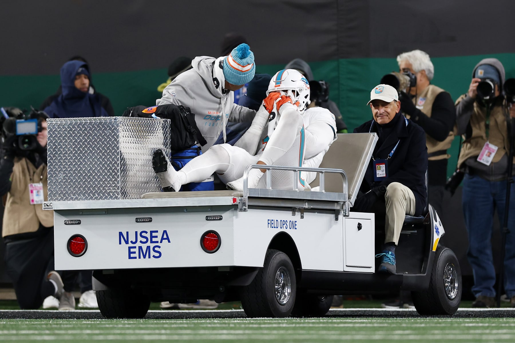 EAST RUTHERFORD, NEW JERSEY - NOVEMBER 24: Jaelan Phillips #15 of the Miami Dolphins is carted off the field after being injured in a play against the New York Jets during the fourth quarter in the game at MetLife Stadium on November 24, 2023 in East Rutherford, New Jersey. (Photo by Rich Schultz/Getty Images)
