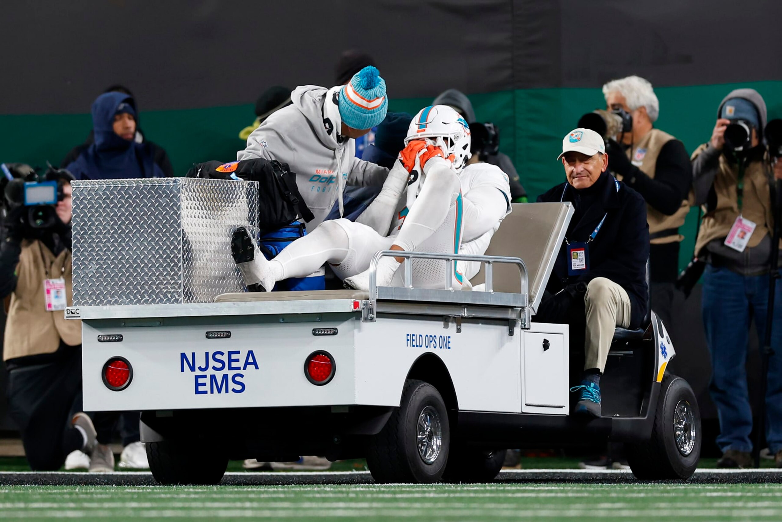 EAST RUTHERFORD, NEW JERSEY - NOVEMBER 24: Jaelan Phillips #15 of the Miami Dolphins is carted off the field after being injured in a play against the New York Jets during the fourth quarter in the game at MetLife Stadium on November 24, 2023 in East Rutherford, New Jersey. (Photo by Rich Schultz/Getty Images)