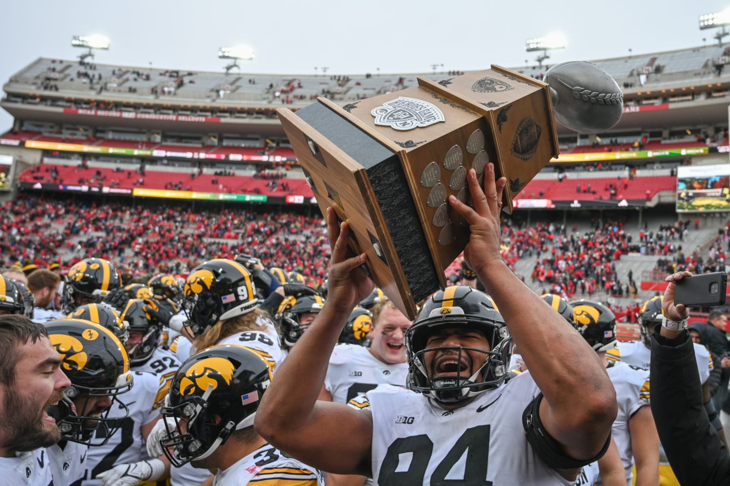 LINCOLN, NEBRASKA - NOVEMBER 24: Defensive lineman Yahya Black #94 of the Iowa Hawkeyes holds up the Heroes Game Trophy after the win against the Nebraska Cornhuskers at Memorial Stadium on November 24, 2023 in Lincoln, Nebraska. (Photo by Steven Branscombe/Getty Images)
