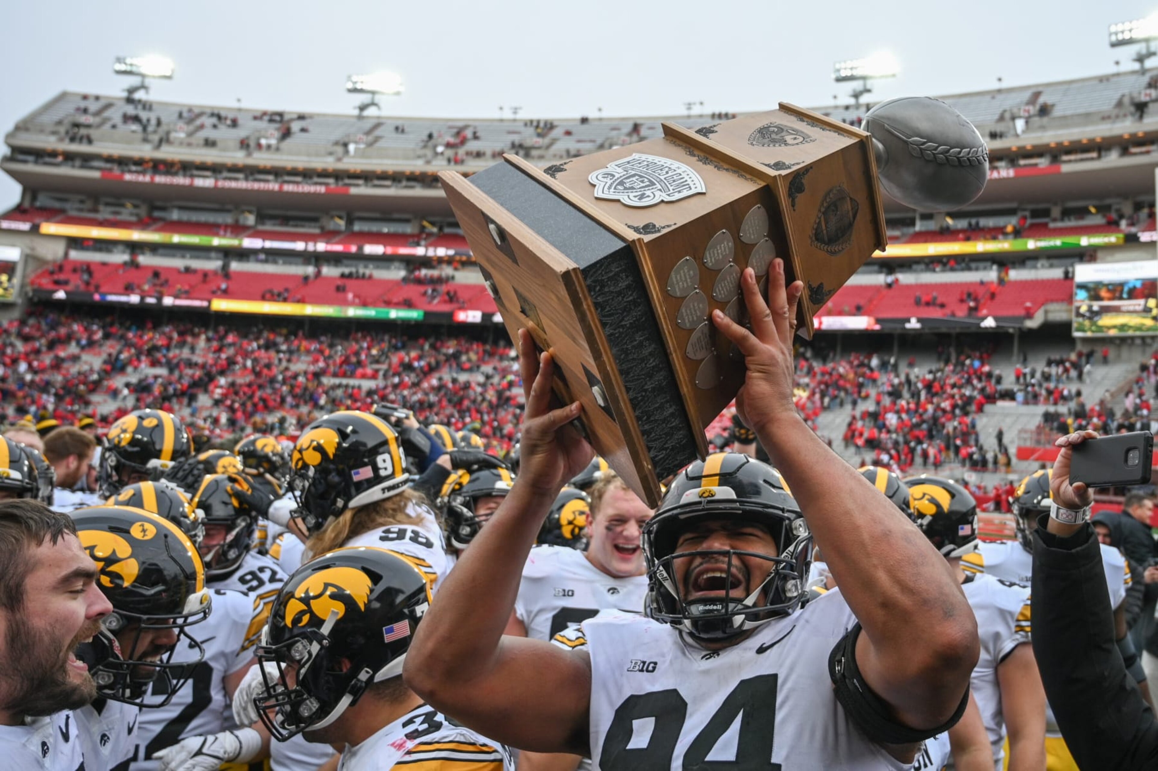 LINCOLN, NEBRASKA - NOVEMBER 24: Defensive lineman Yahya Black #94 of the Iowa Hawkeyes holds up the Heroes Game Trophy after the win against the Nebraska Cornhuskers at Memorial Stadium on November 24, 2023 in Lincoln, Nebraska. (Photo by Steven Branscombe/Getty Images)
