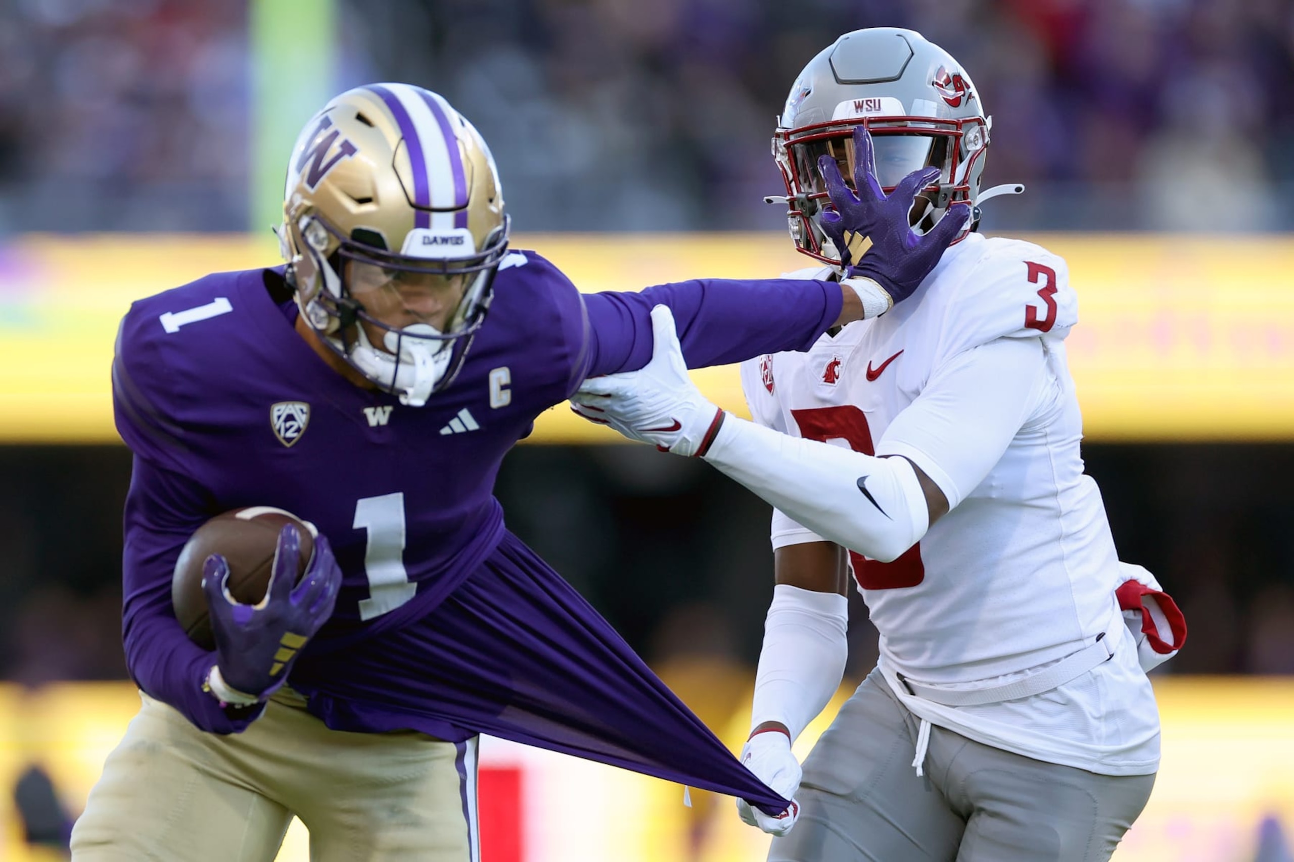 SEATTLE, WASHINGTON - NOVEMBER 25: Cam Lampkin #3 of the Washington State Cougars tackles Rome Odunze #1 of the Washington Huskies during the first quarter at Husky Stadium on November 25, 2023 in Seattle, Washington. (Photo by Steph Chambers/Getty Images)
