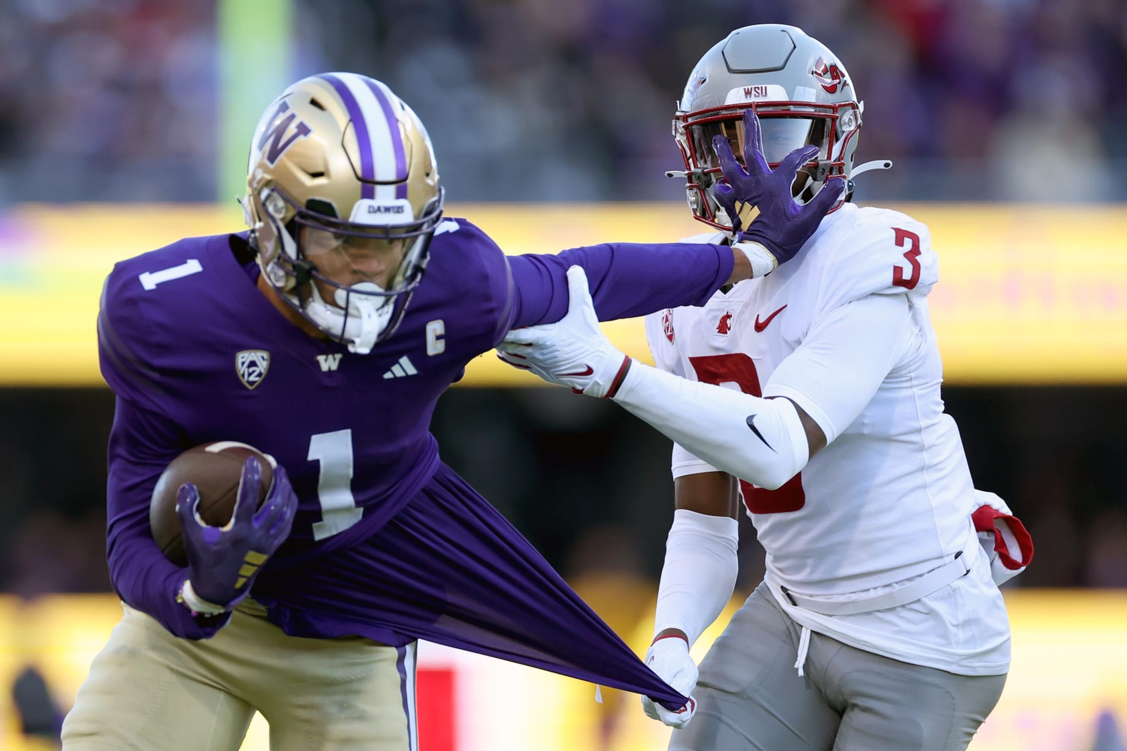 SEATTLE, WASHINGTON - NOVEMBER 25: Cam Lampkin #3 of the Washington State Cougars tackles Rome Odunze #1 of the Washington Huskies during the first quarter at Husky Stadium on November 25, 2023 in Seattle, Washington. (Photo by Steph Chambers/Getty Images)