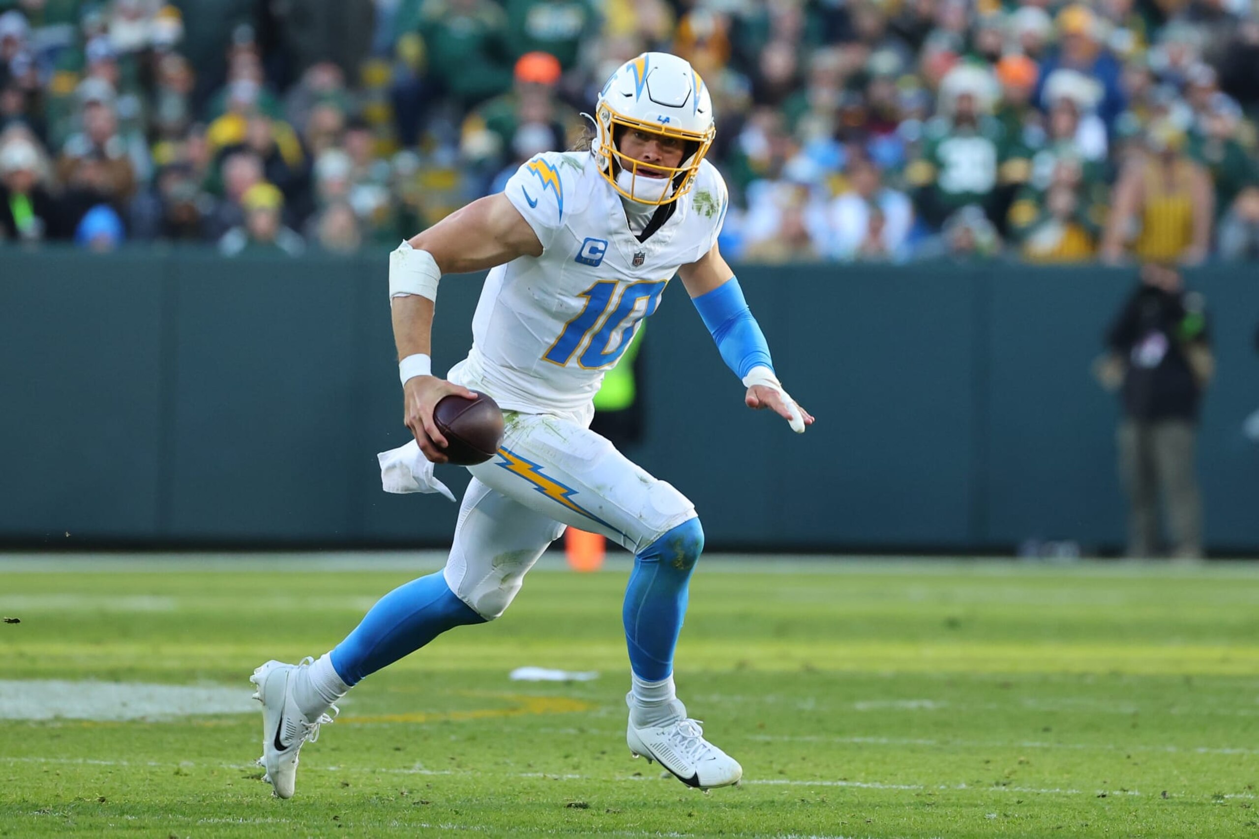 GREEN BAY, WISCONSIN - NOVEMBER 19: Justin Herbert #10 of the Los Angeles Chargers runs for yards during a game against the Green Bay Packers at Lambeau Field on November 19, 2023 in Green Bay, Wisconsin. The Packers defeated the Chargers 23-20. (Photo by Stacy Revere/Getty Images)