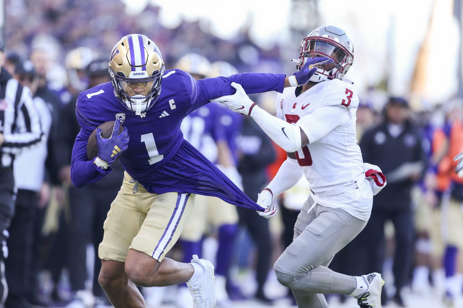 SEATTLE, WA - November 25:  Washington #1 (WR) Rome Odunze breaks up field as Washington State #3 (DB) Cam Lampkin hangs onto his jersey during the 115 Apple Cup college football game between the Washington Huskies and the Washington State Cougars on November 25, 2023, at Husky Stadium in Seattle, WA. (Photo by Jesse Beals/Icon Sportswire via Getty Images)